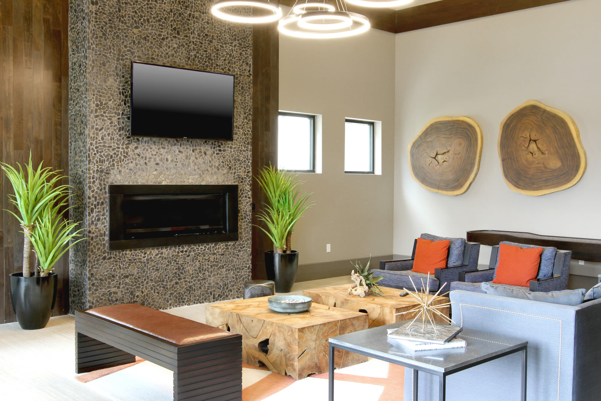 Modern clubhouse with fireplace and flatscreen tv in sitting area at Henley at The Rim in San Antonio, Texas