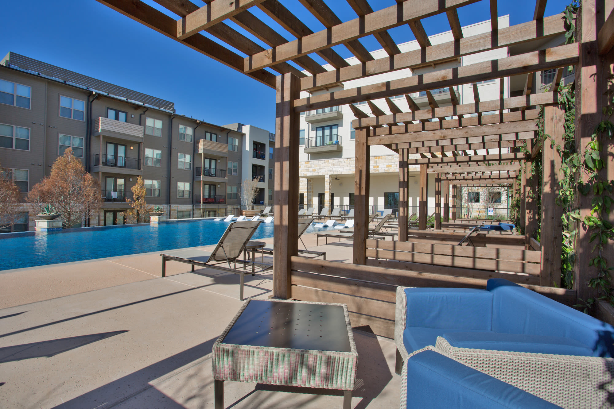 Community pool and sitting area at Henley at The Rim in San Antonio, Texas