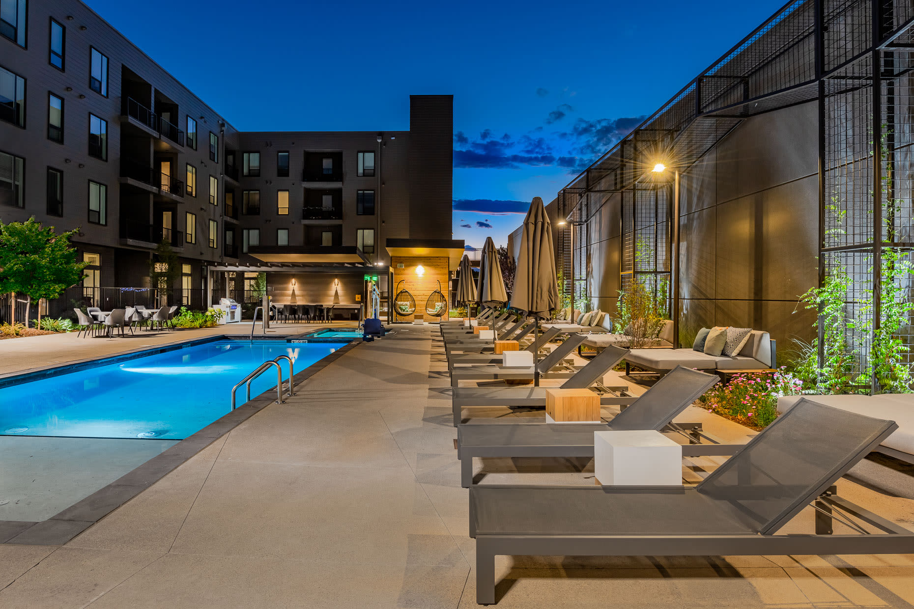 Spacious sitting area by pool with lounge chairs at West 38 in Wheat Ridge, Colorado