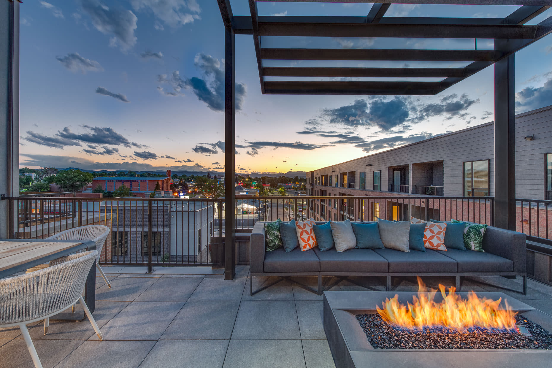 Sitting are with cushioned benches by firepit at  West 38 in Wheat Ridge, Colorado