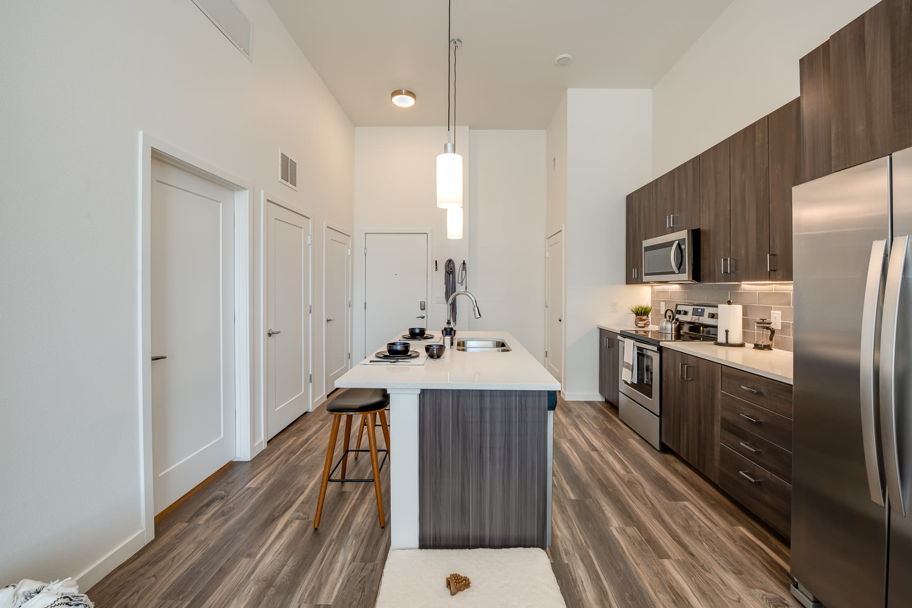 Fully appointed kitchen with wood-style floors at West 38 in Wheat Ridge, Colorado