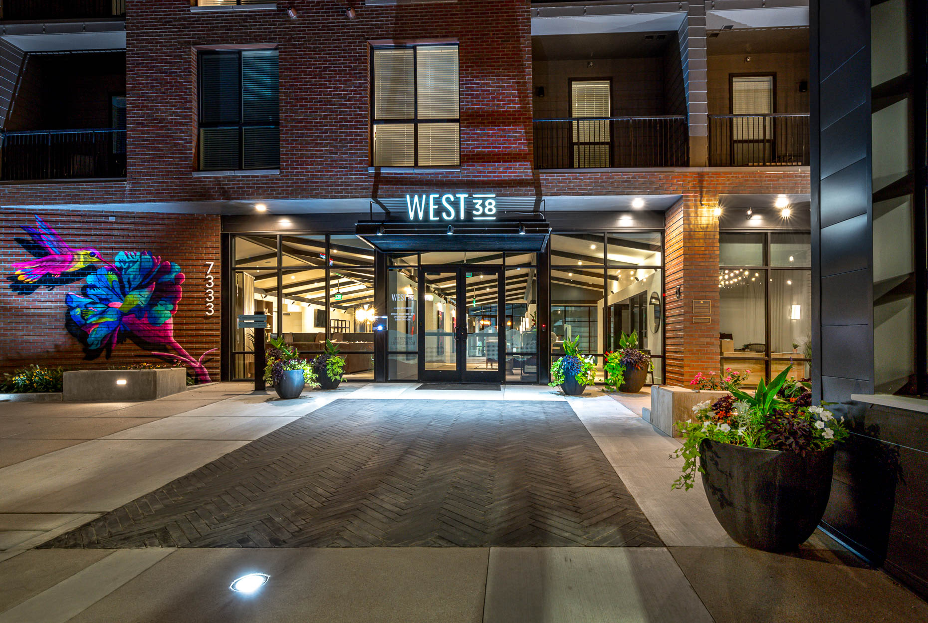 Front view of entrance at night at West 38 in Wheat Ridge, Colorado