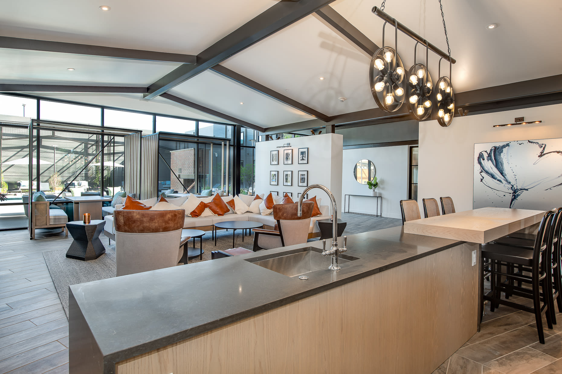 Wet bar and seating area with modern lighting in the clubhouse at West 38 in Wheat Ridge, Colorado