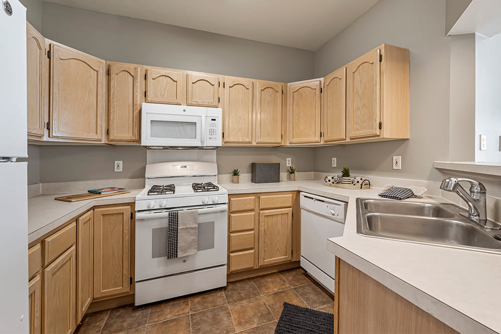 Beautiful modern kitchen with white appliances at Lake Pointe Apartment Homes in Portage, Indiana