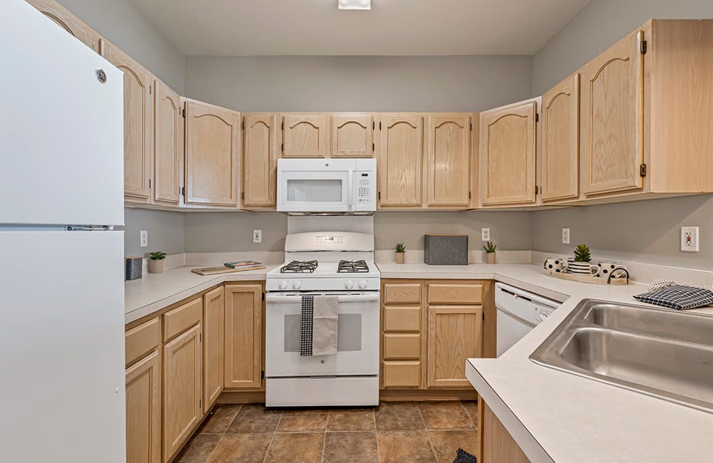 Kitchen with white appliances at Lake Pointe Apartment Homes in Portage, Indiana