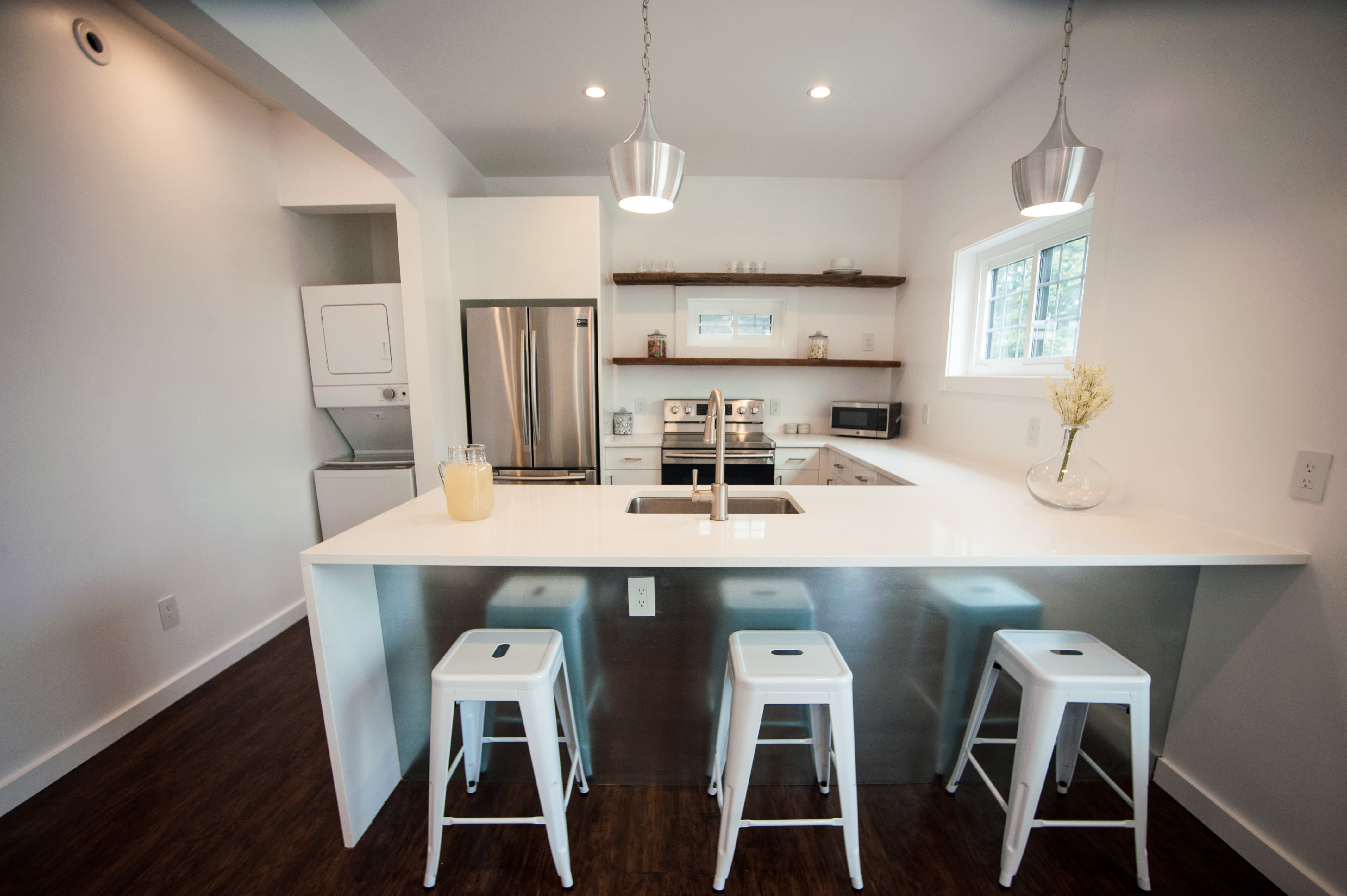 Student apartment's kitchen with barstool seats at Campus Prime in Syracuse, New York