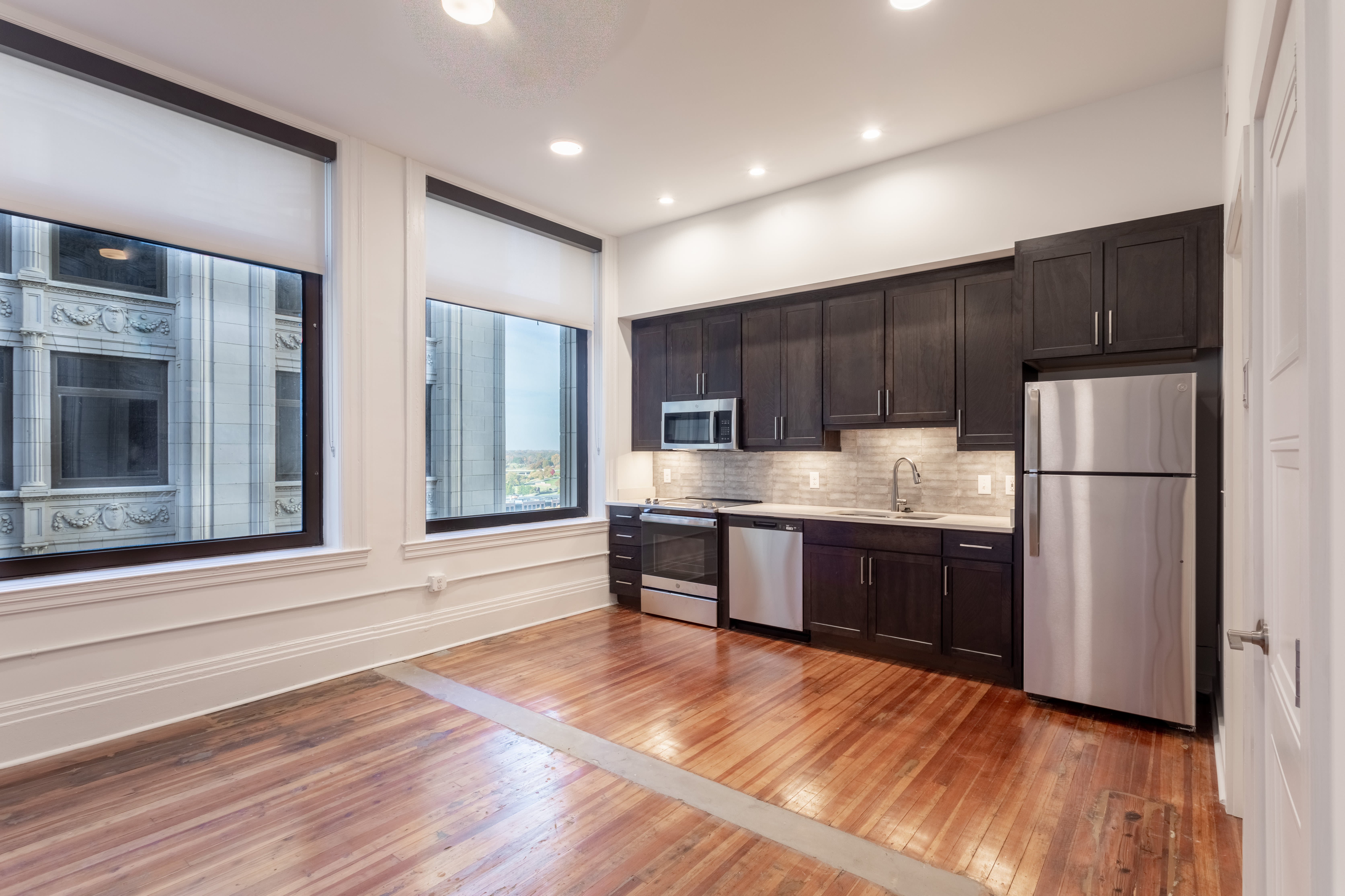 Large windows and stainless-steel appliances in a home at Mutual on Main in Richmond, Virginia