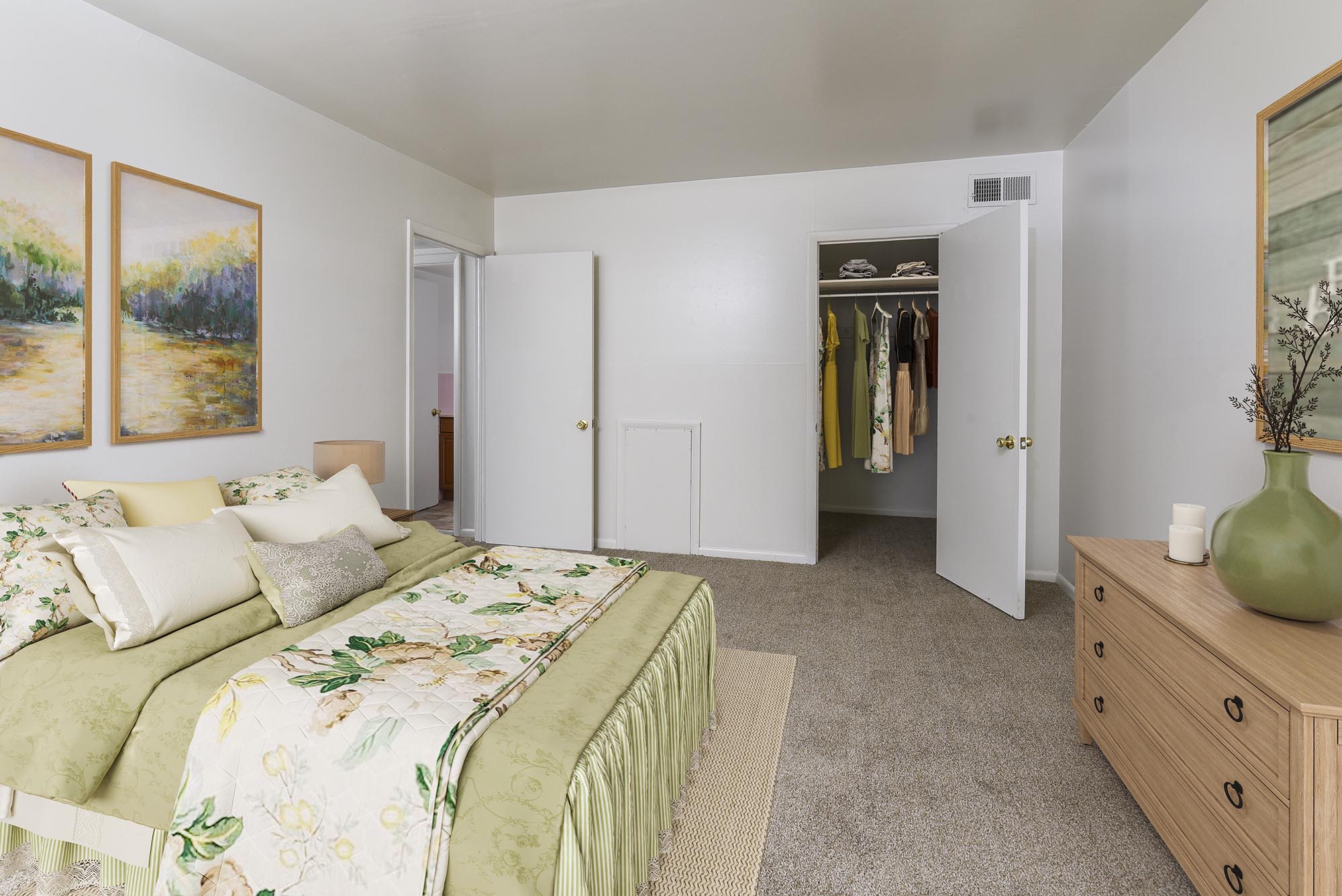 Model bedroom with plush carpeting and a walk-in closet at Westover Pointe, Wilmington, Delaware