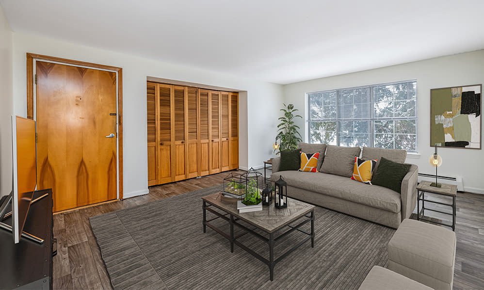 Staged living room with large closets at Green Lake Apartments & Townhomes in Orchard Park, New York