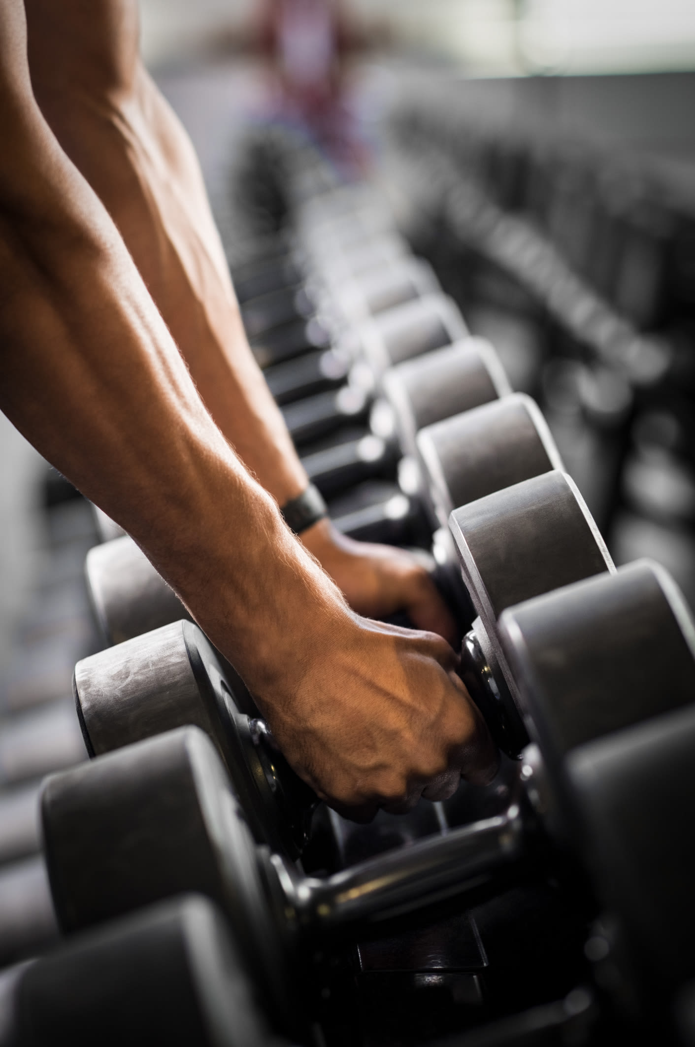 Resident picking up weights from the fitness facility at Parc at West Point in North Wales, Pennsylvania