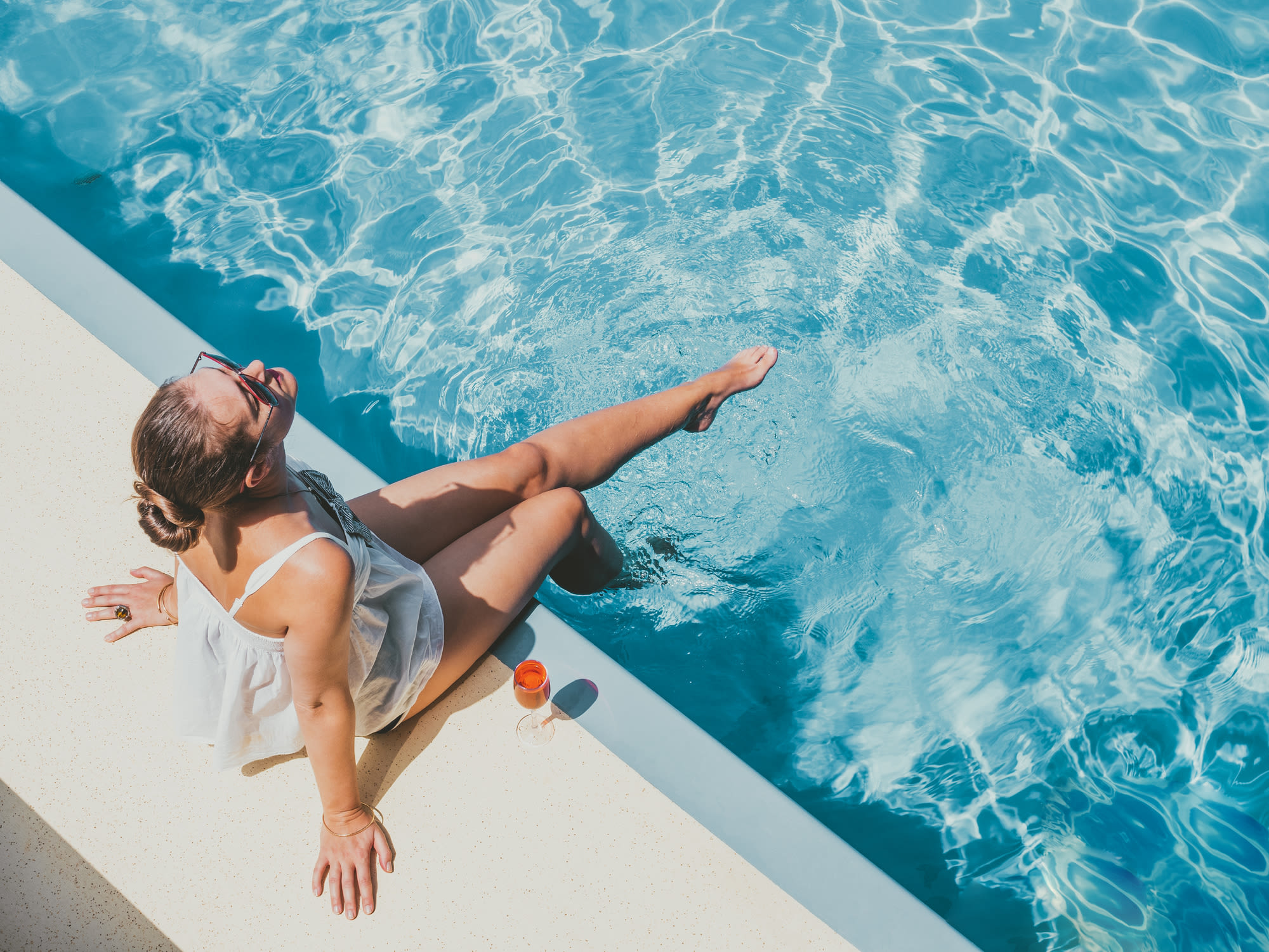 Resident lounging by the pool at The Flats at Columbia Pike in Silver Spring, Maryland