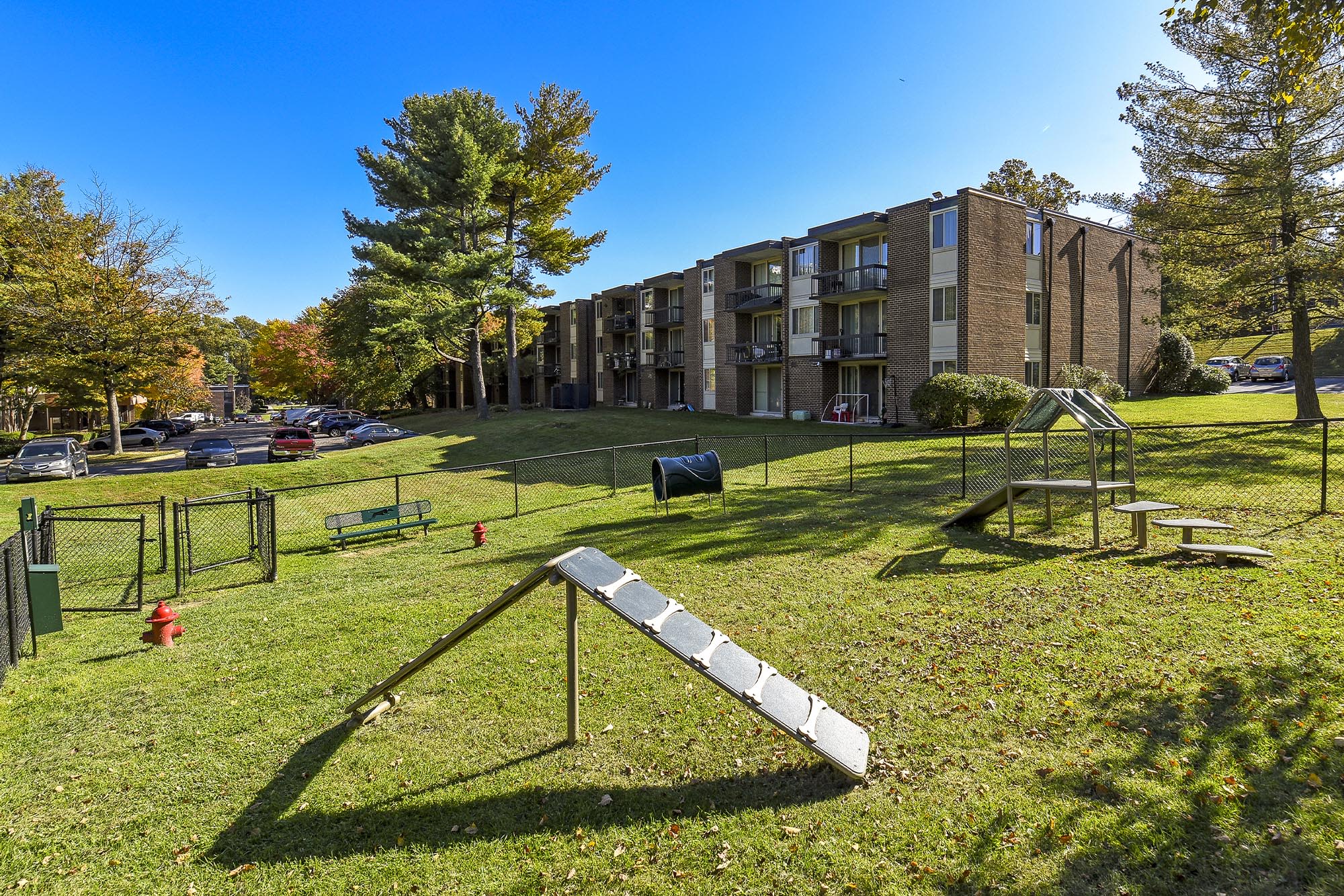 Dog park with agility equipment at Landmark Glenmont Station in Silver Spring, Maryland