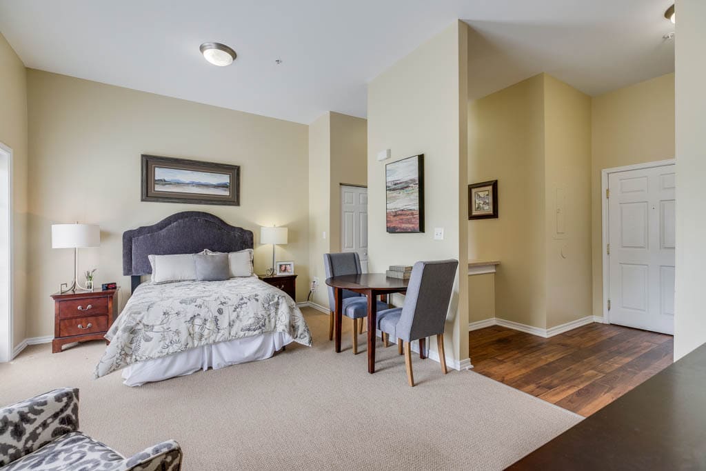 Cozy bedroom at Arcadia Senior Living Louisville in Louisville, Kentucky