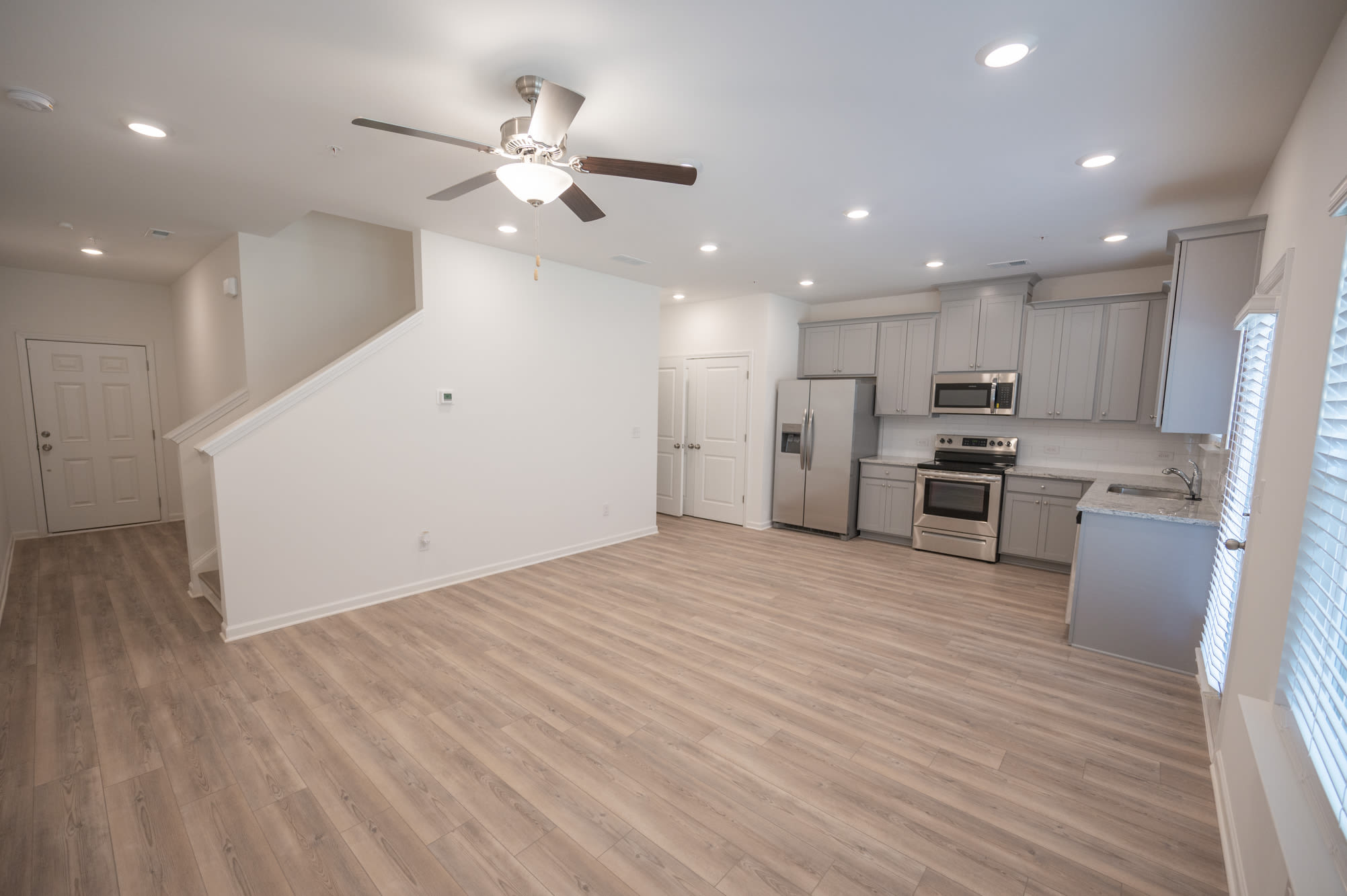 Living room with wood-style floors at Parallel 36 at Jailette in Atlanta, Georgia