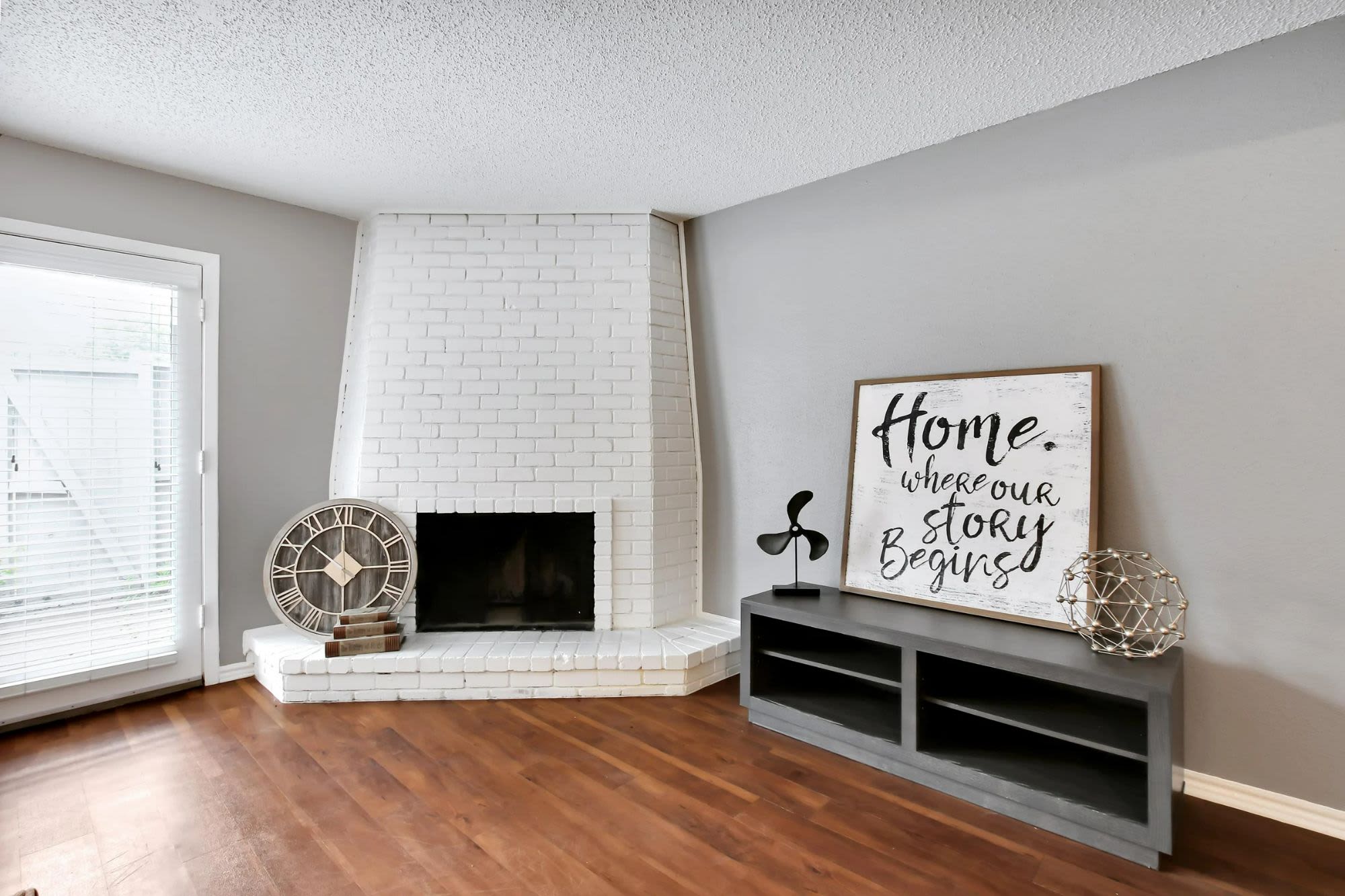 Apartment living room with tan colored wooden flooring at Parkwyn Townhomes in North Richland Hills,Texas