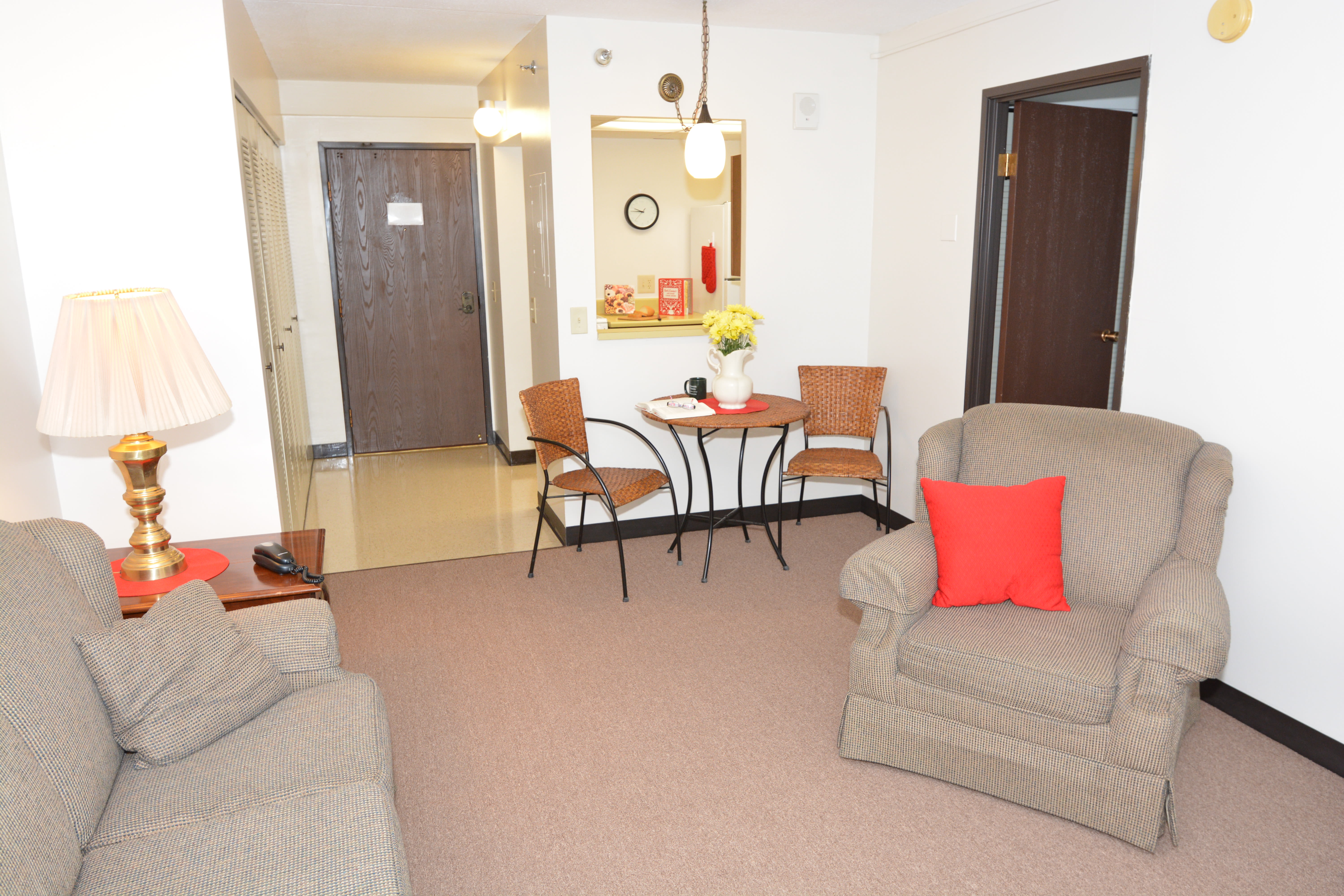 Living space with wall-to-wall carpeting at Riverside Towers in Coshocton, Ohio