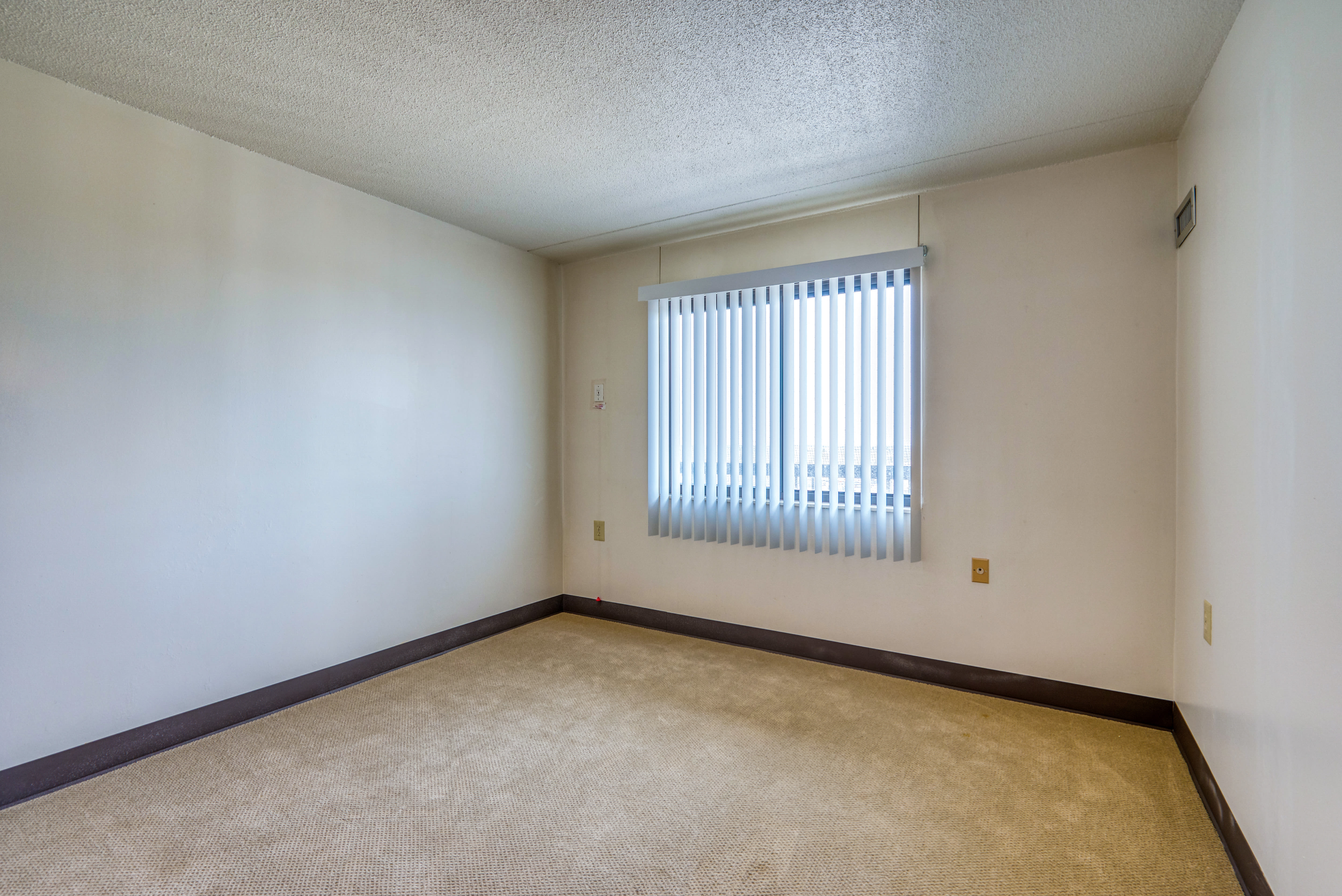 Model bedroom with soft carpet at Cambridge Towers in Detroit, Michigan