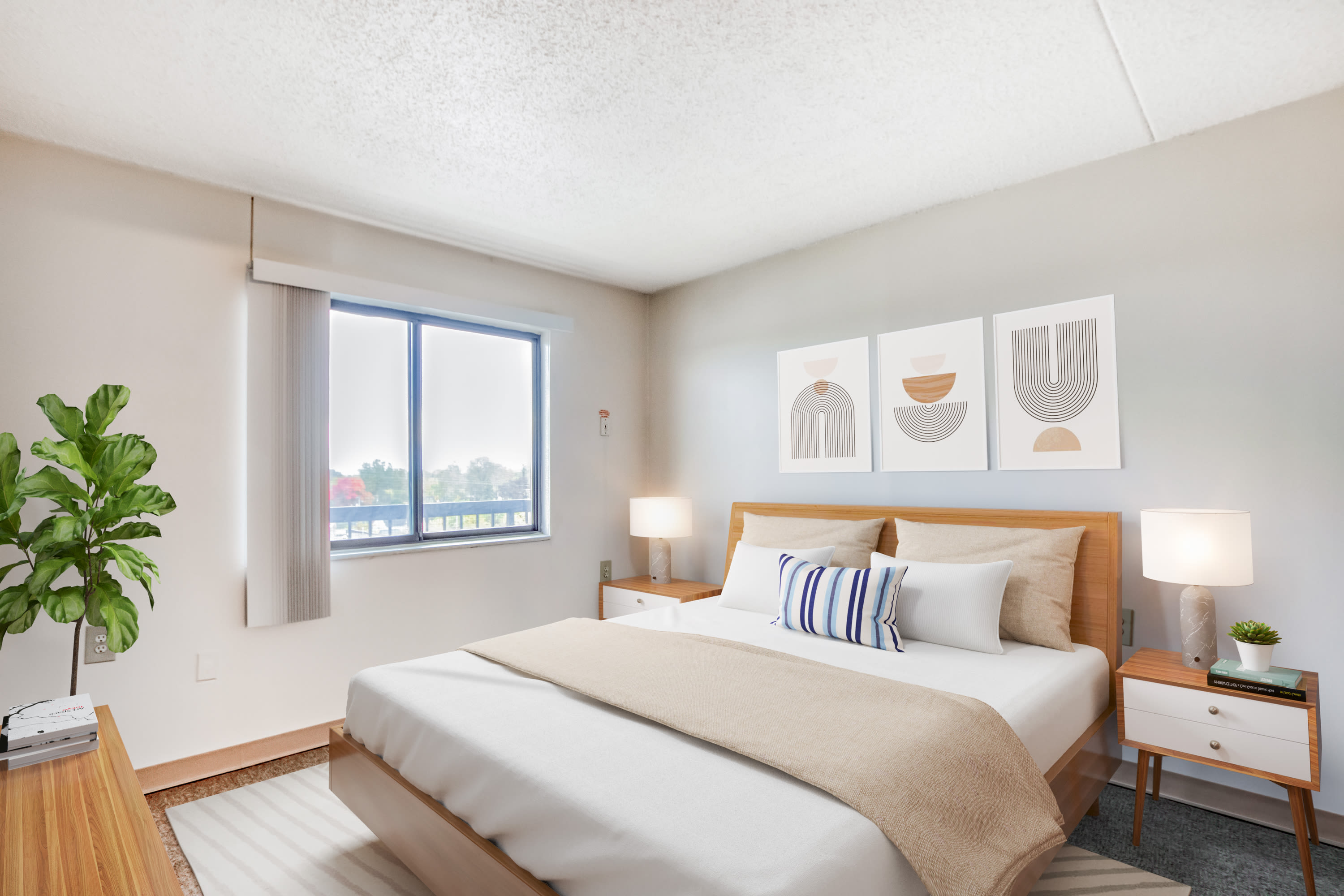 Bedroom with soft carpet in a model apartment at Bowin Place in Detroit, Michigan