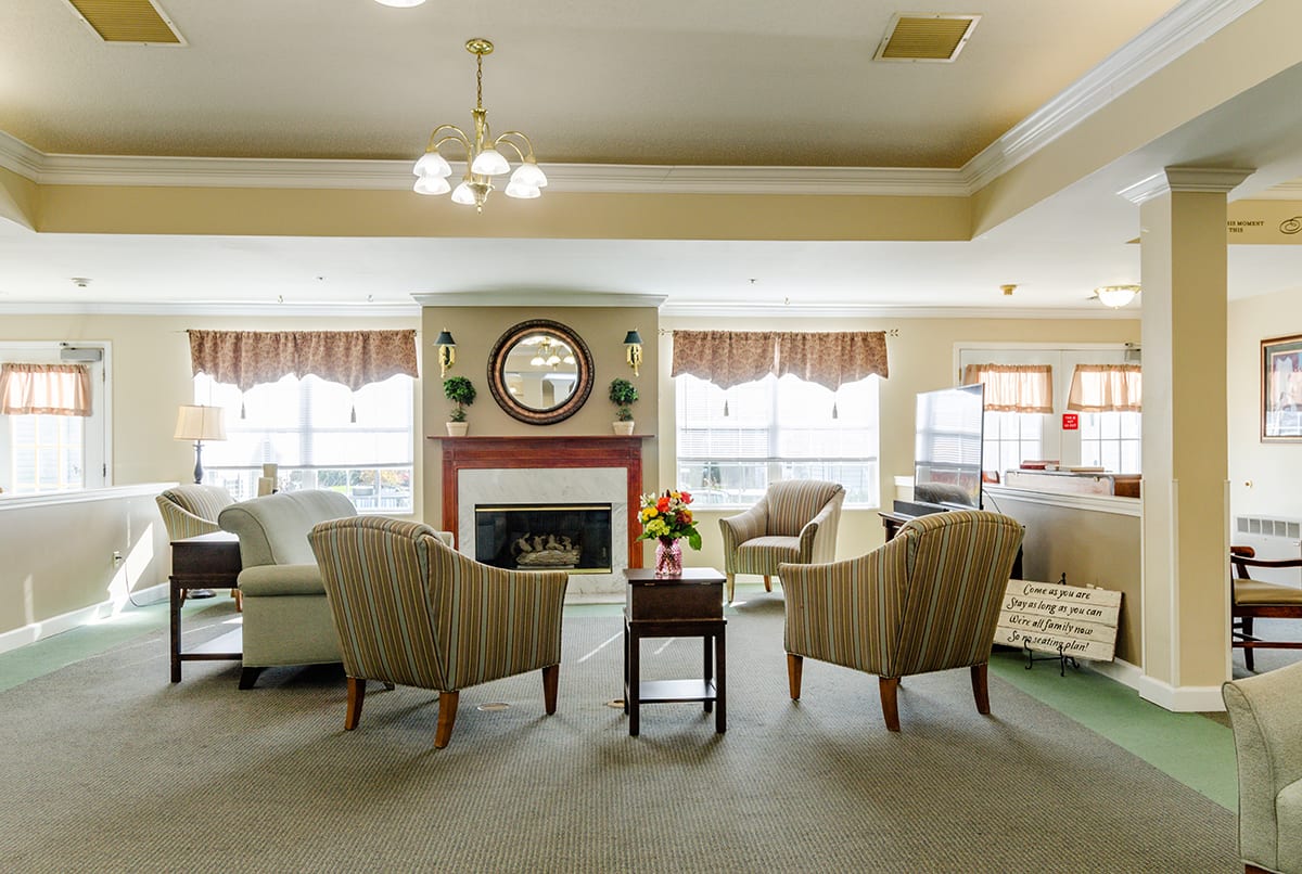 Resident lounge area with fireplace at Trustwell Living at Oakley Place in Greenville, Ohio