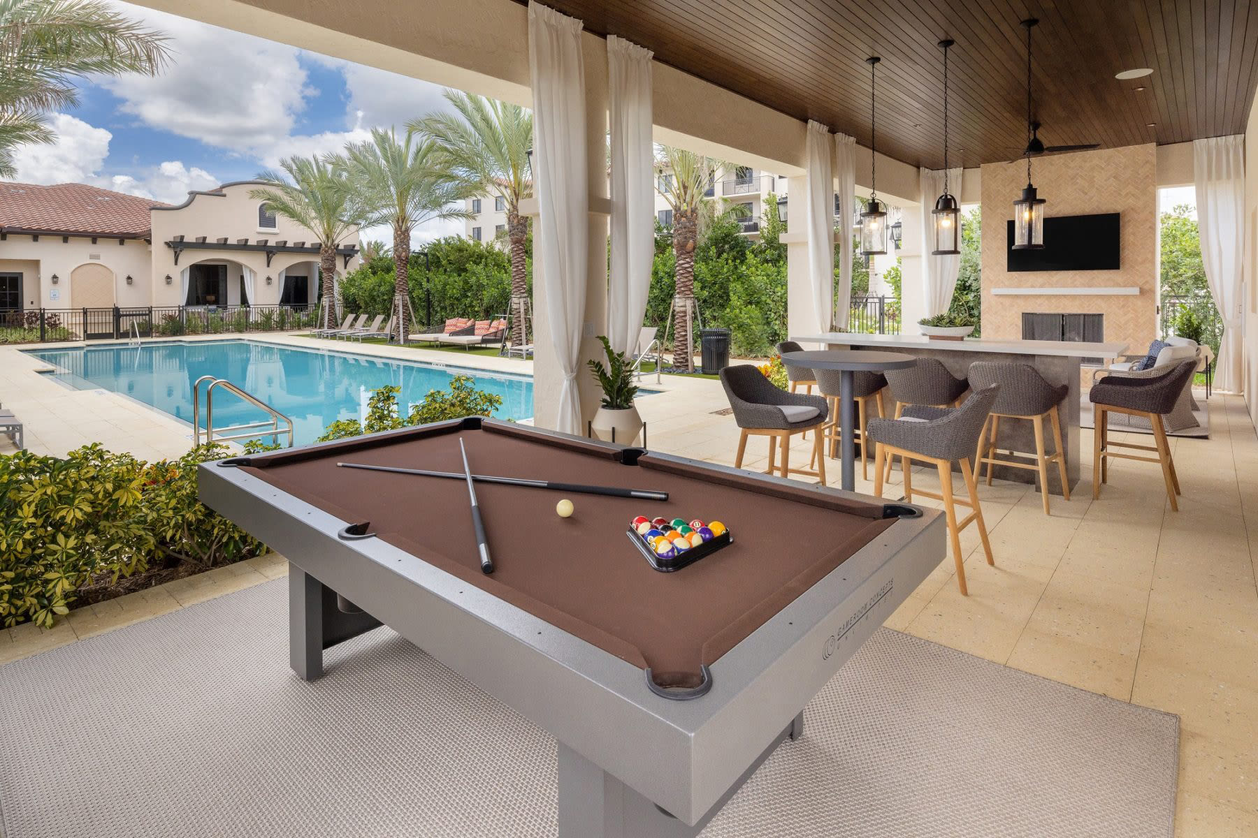 Poolside billiards table at Locklyn West Palm in West Palm Beach, Florida