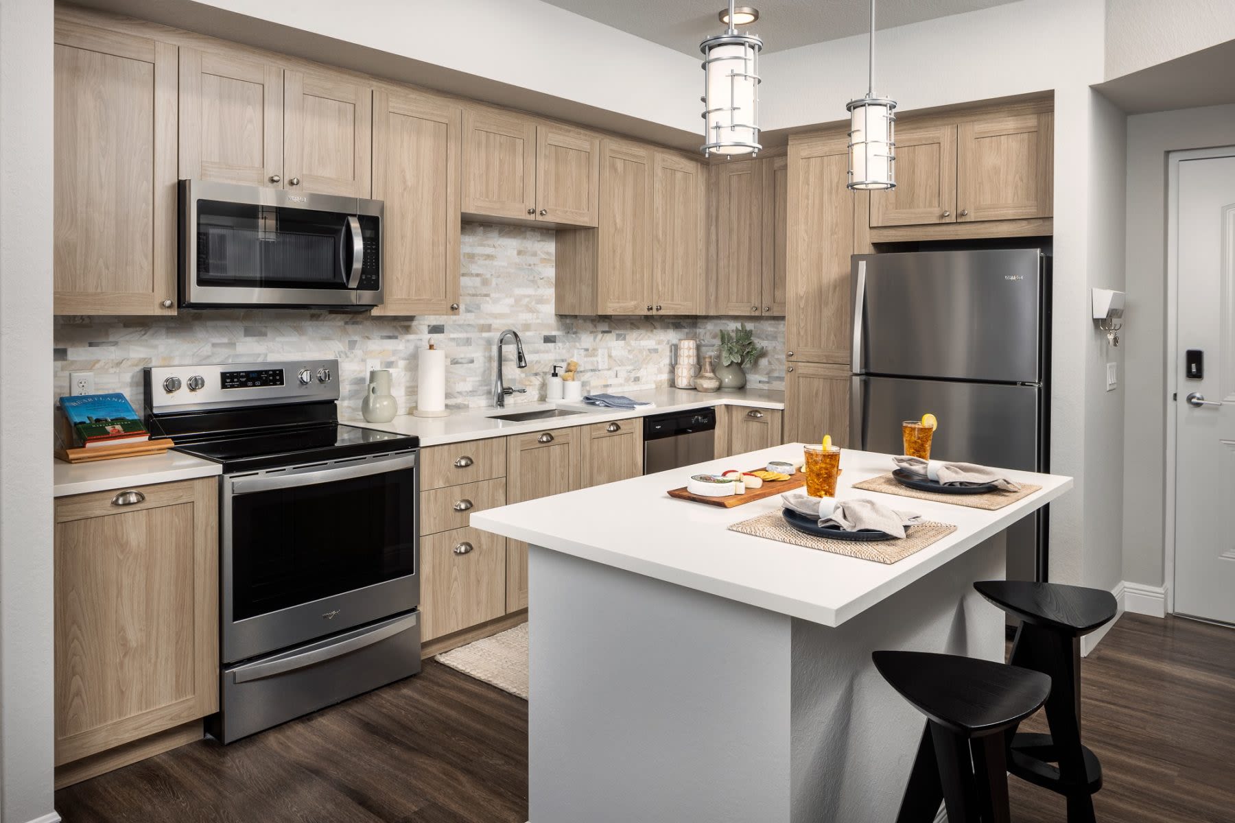 Kitchen with stainless steel appliances at Locklyn West Palm in West Palm Beach, Florida