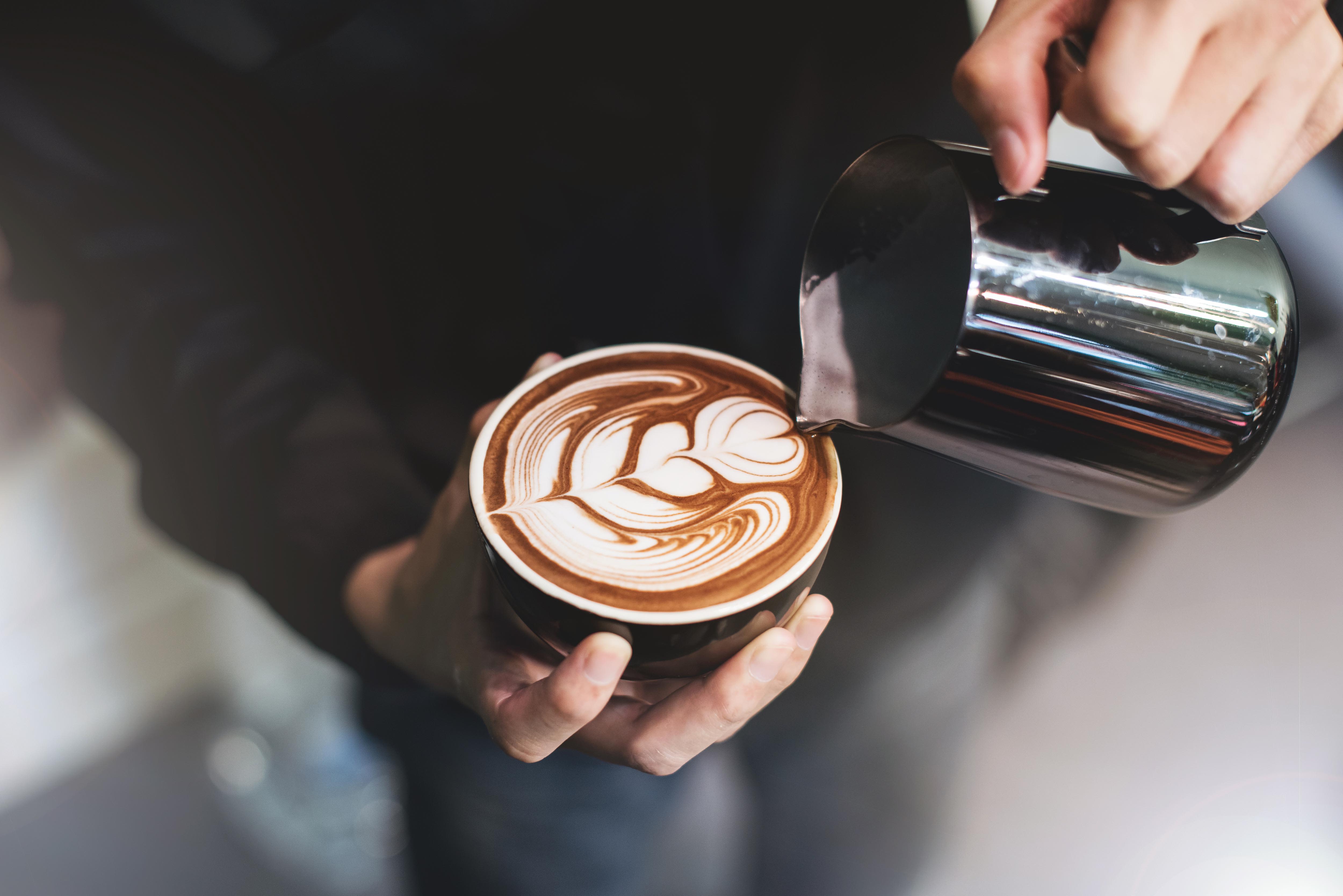 Resident having some warm cups of coffee at a shop near Arcadia at Rivers Edge in Medford, Massachusetts