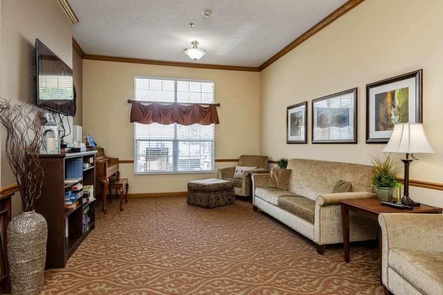 Resident apartment with sofa and large television at Trustwell Living at Urbana Place in Urbana, Ohio