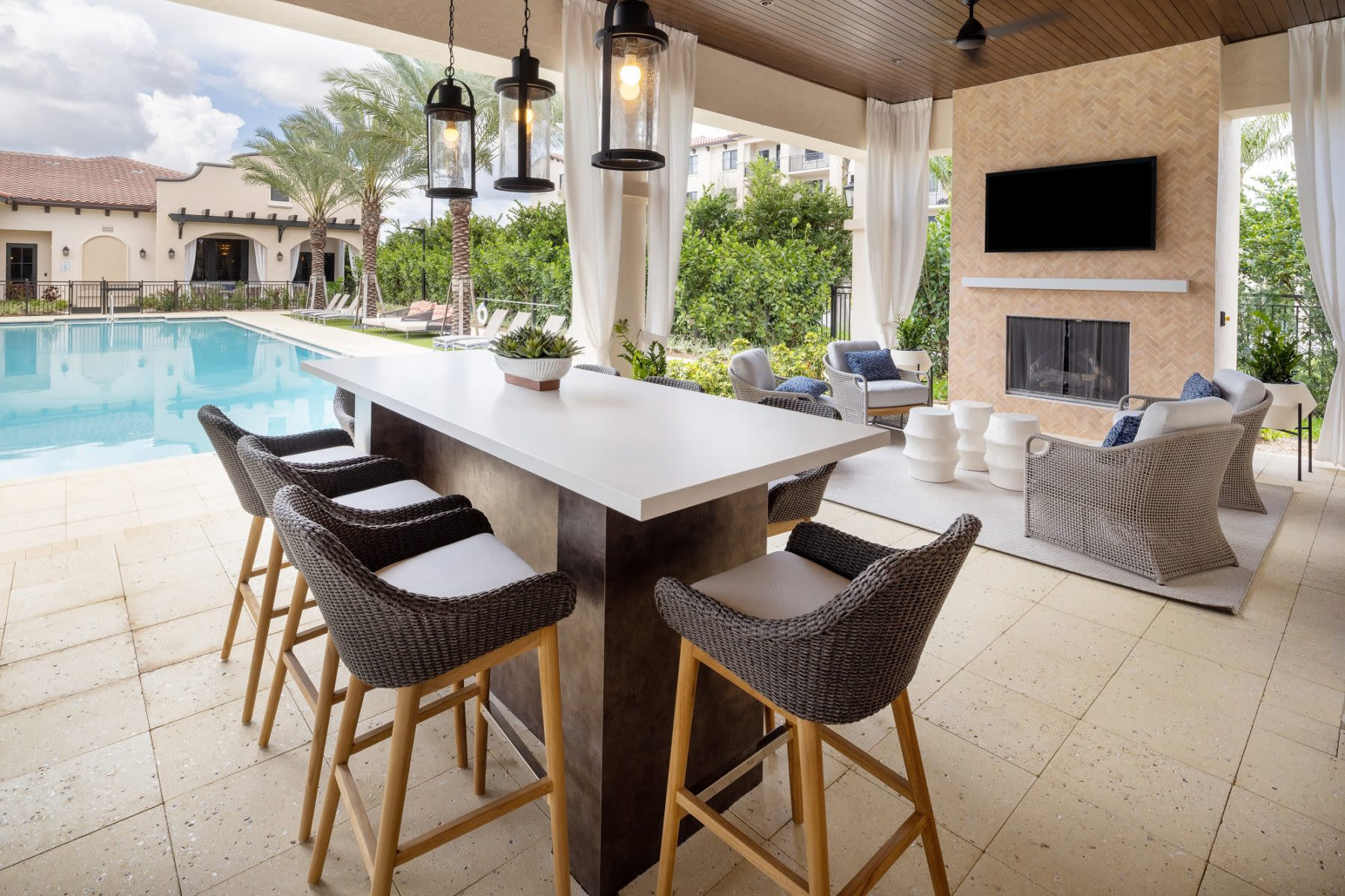 Comfortable poolside seating amidst palm trees at Locklyn West Palm, West Palm Beach, Florida