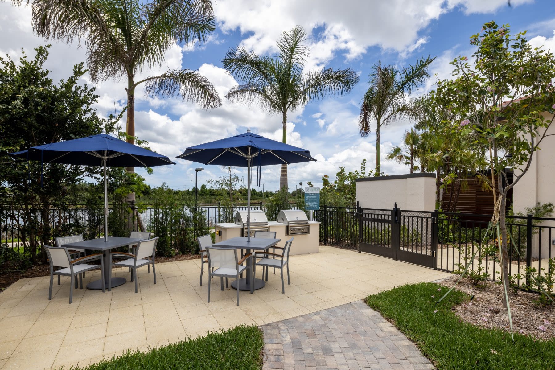 umbrellas and clubhouse seating at Locklyn West Palm in West Palm Beach, Florida