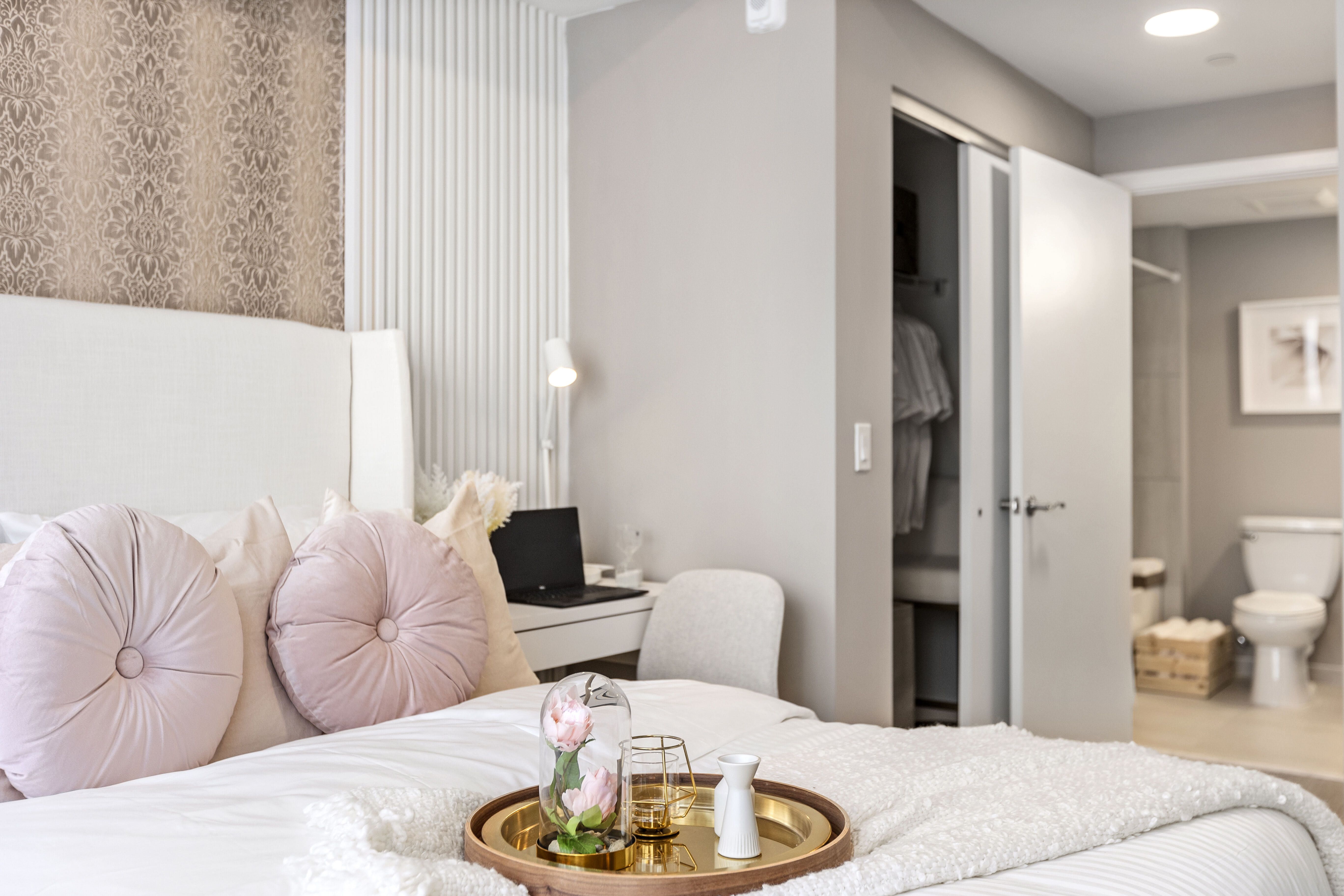 Discover a furnished apartment model bedroom at Pine Ridge in West Palm Beach, Florida, where natural light, modern furnishings, and wood-style flooring combine for a stylish living space