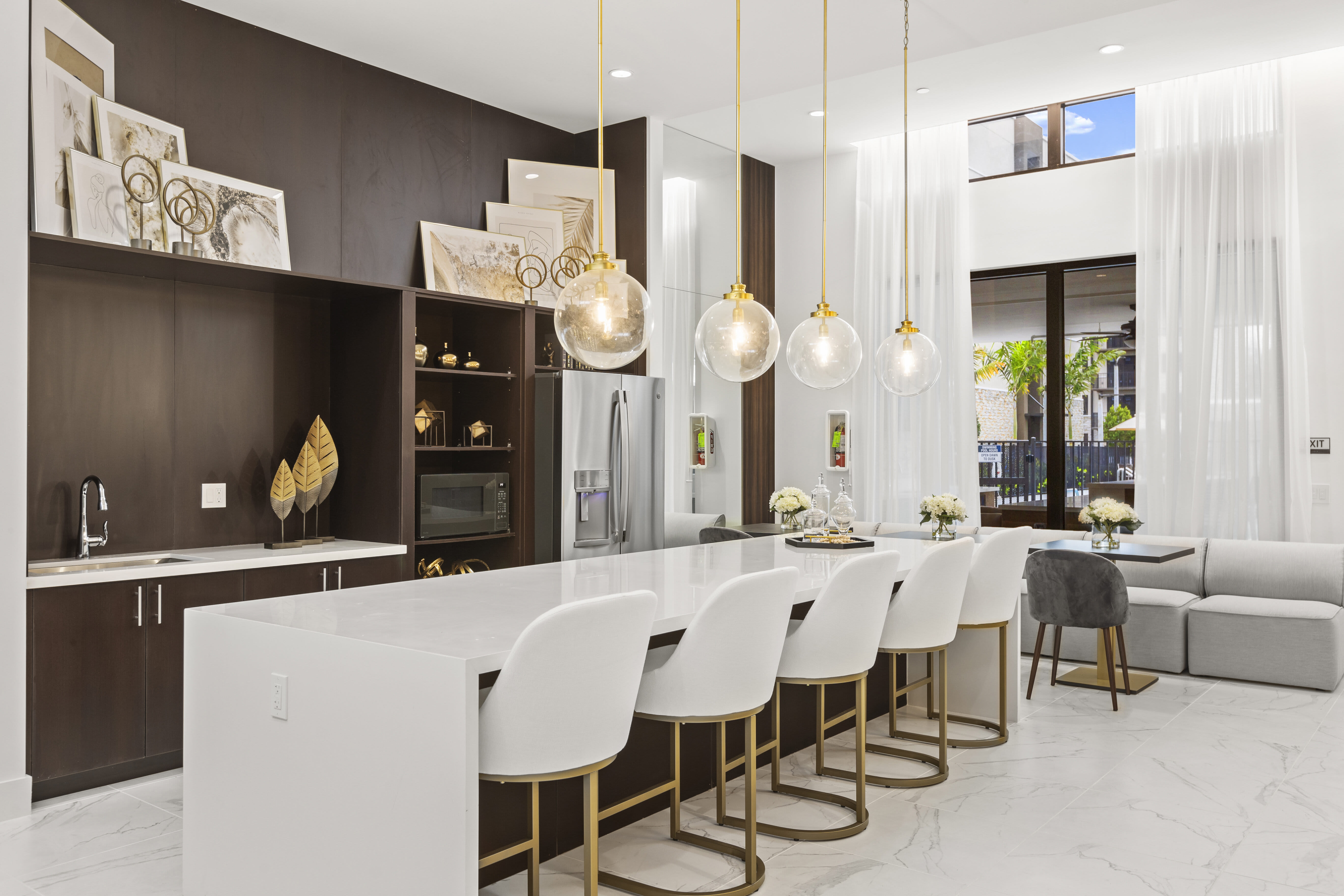 Stylish clubhouse with high-end lighting, modern furnishings, and cozy seating at Pine Ridge, West Palm Beach, Florida