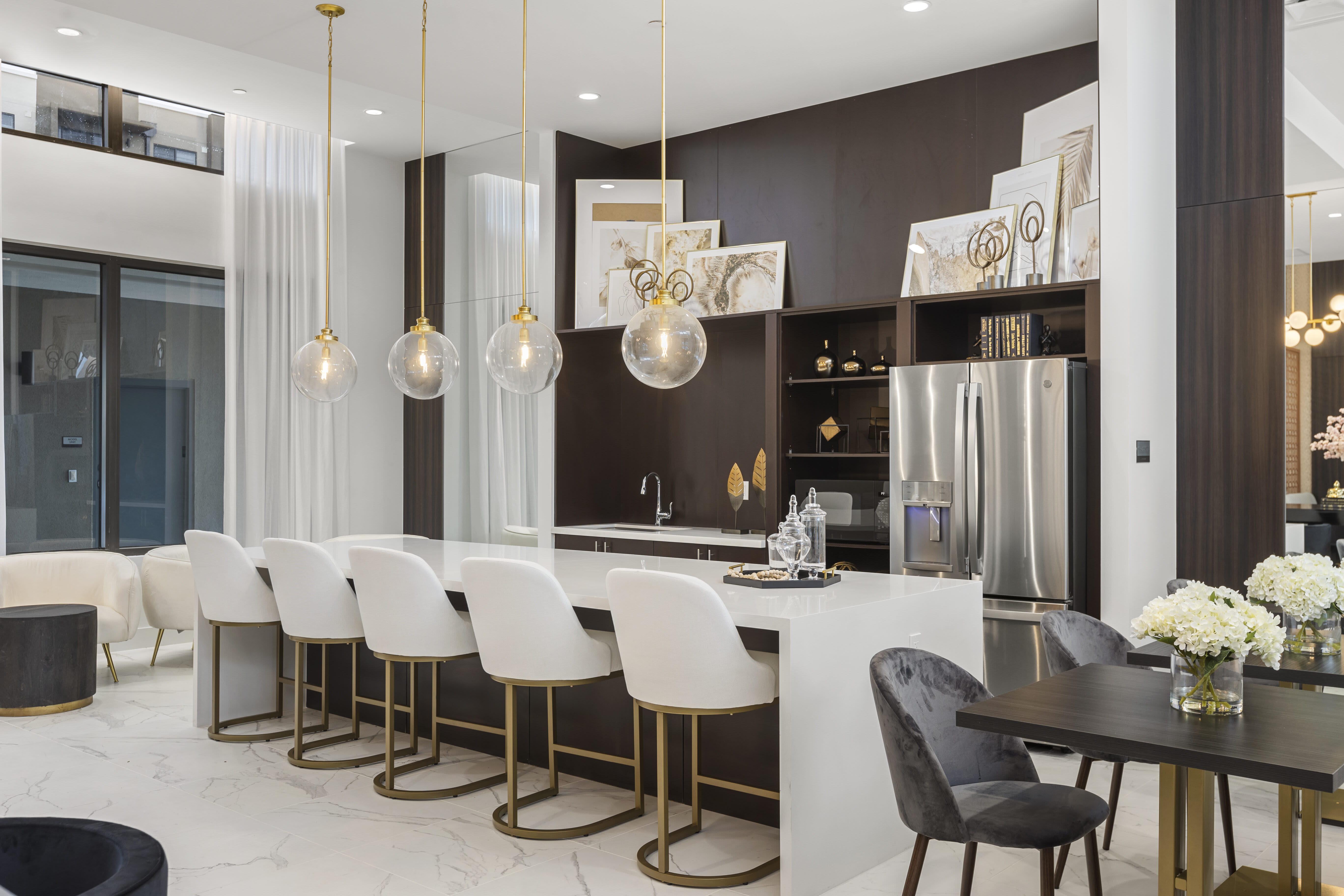 Upscale clubhouse featuring modern furnishings, high-end lighting, and comfortable seating at Pine Ridge, West Palm Beach, Florida