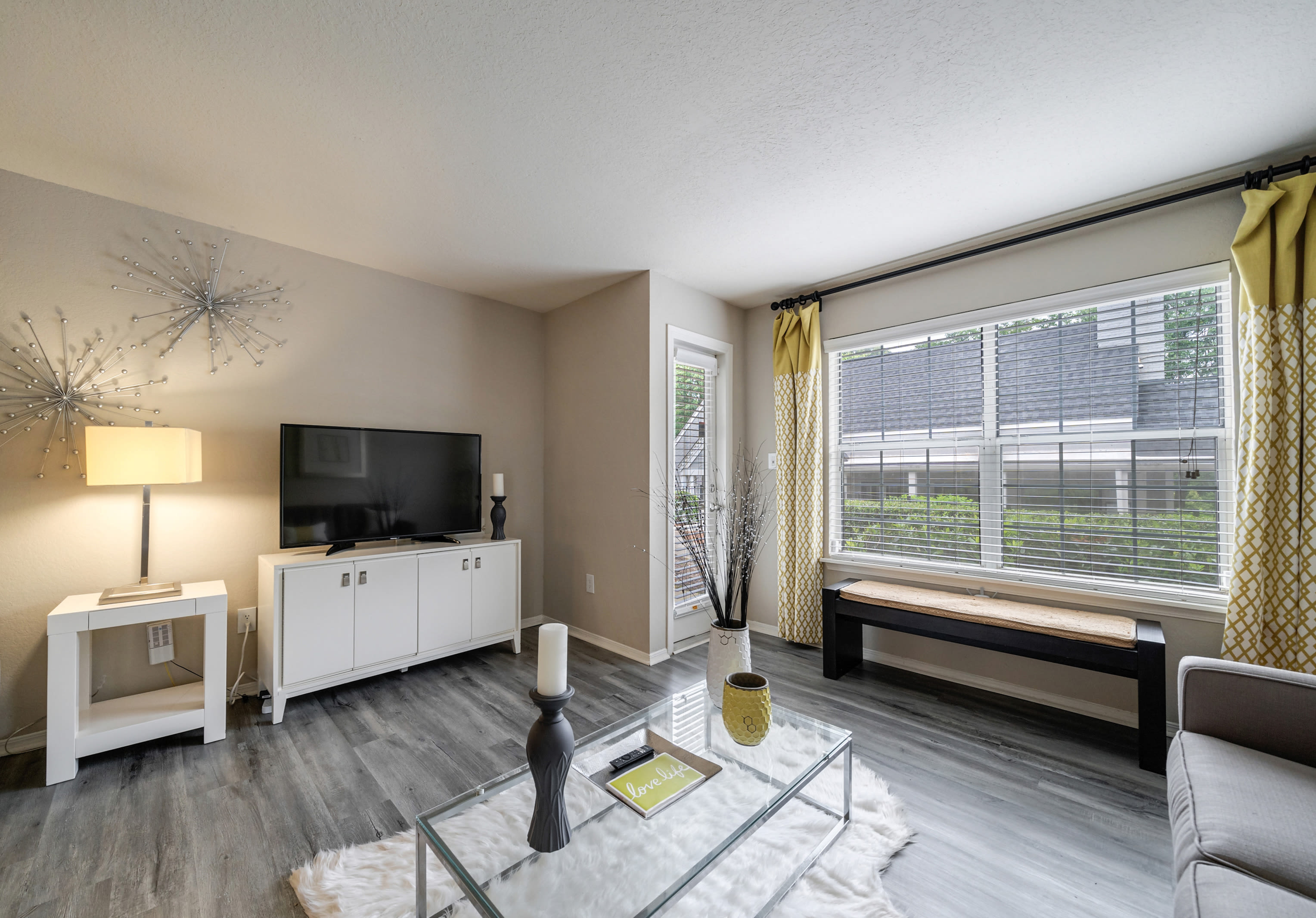 Living room and dining area in an open concept apartment home at Castlegate Collier Hills in Atlanta, Georgia