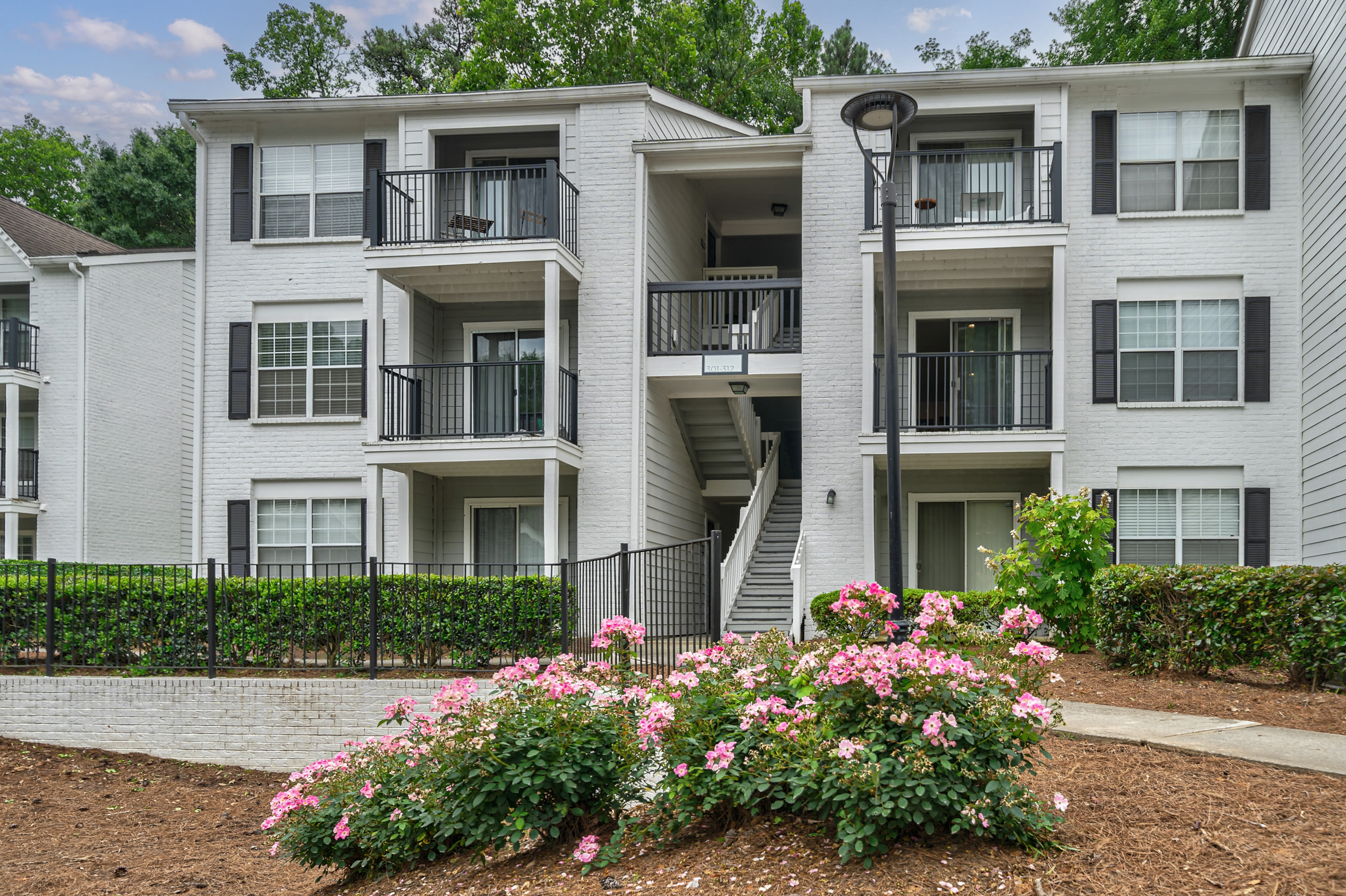 Building exterior with private patio at Castlegate Collier Hills in Atlanta, Georgia