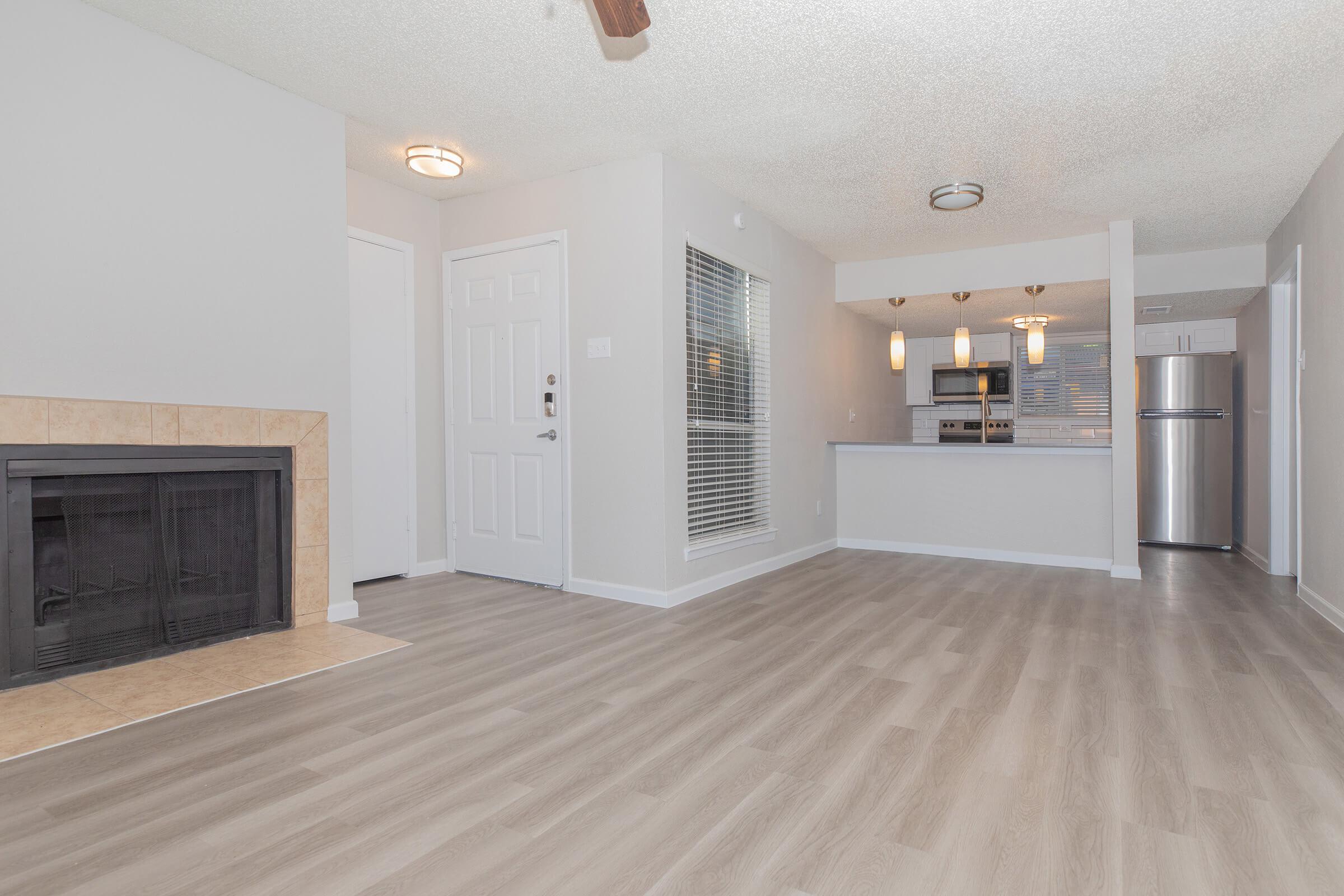 Spacious apartment with wood-style flooring at Tides on Green Oaks in Arlington, Texas