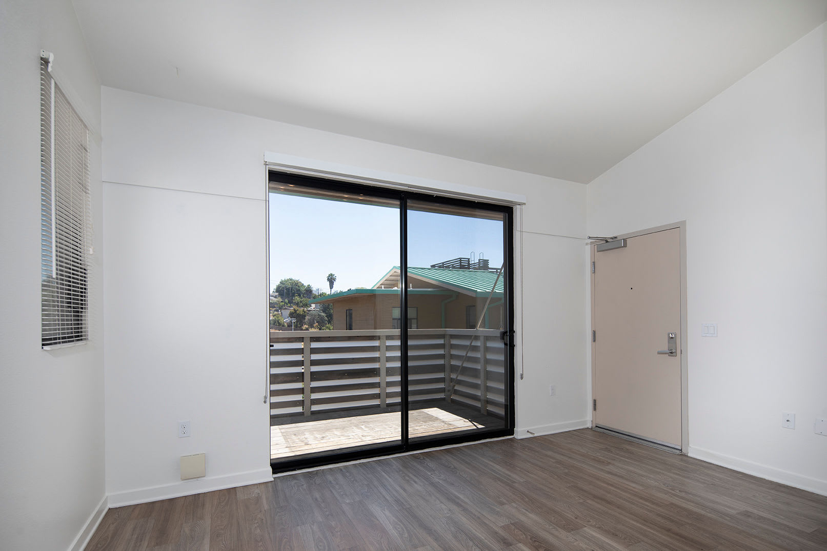 Model master bedroom with a balcony at The Quarry Apartments in La Mesa, California