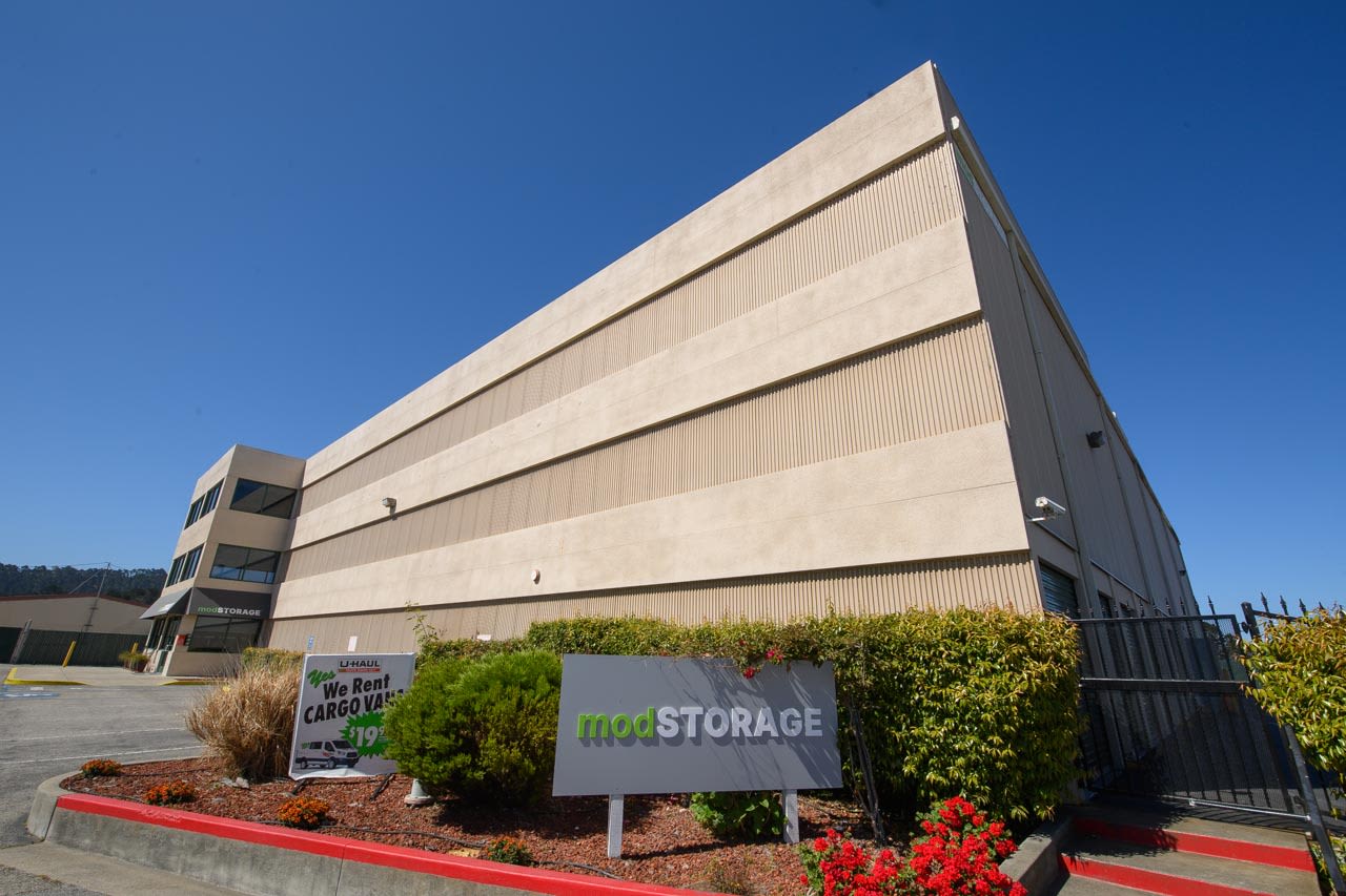 Two men moving boxes at modSTORAGE Airport Road in Monterey, California