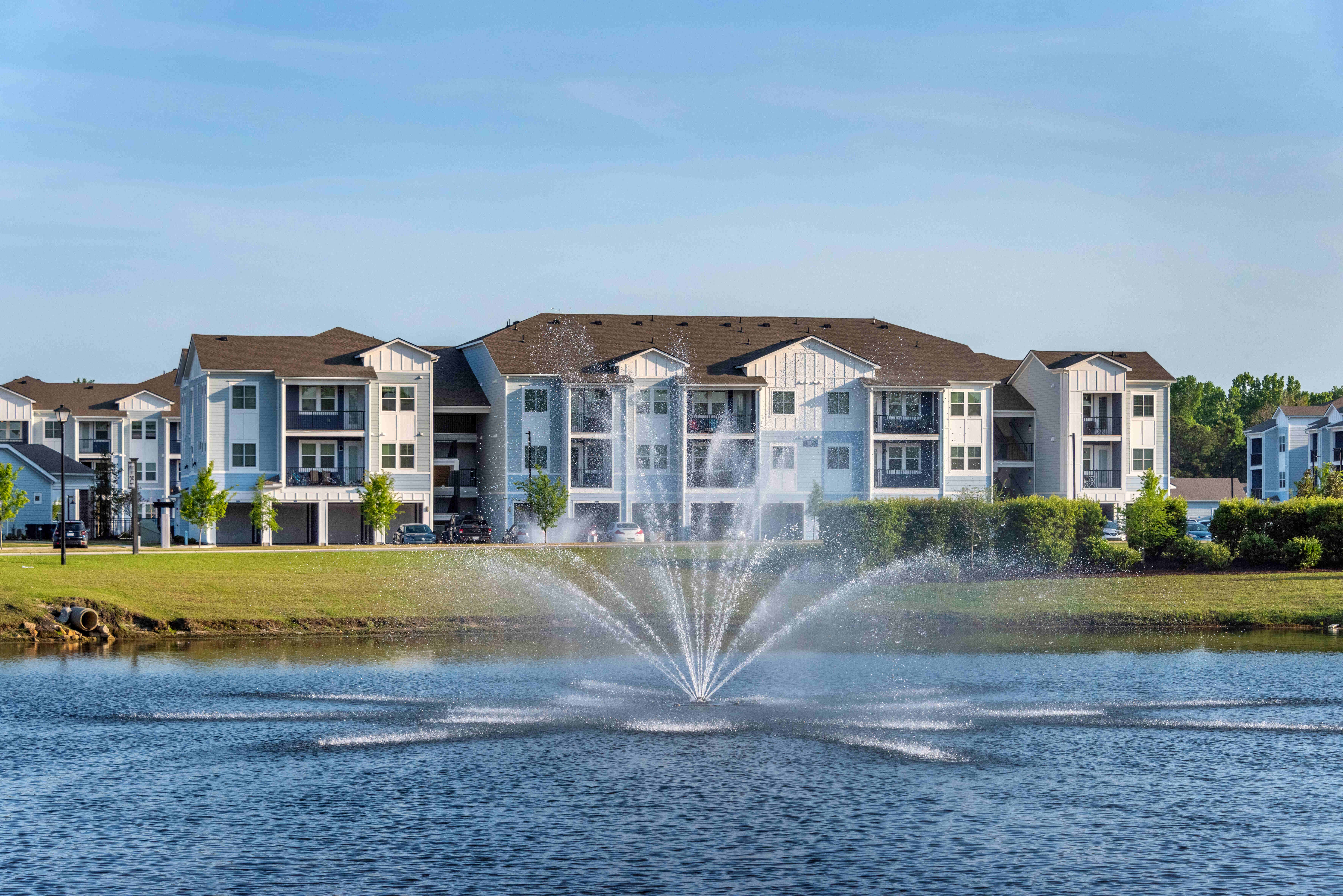 Exterior view of the fountain and pond and apartments at Artisan Carolina Forest in Myrtle Beach, South Carolina