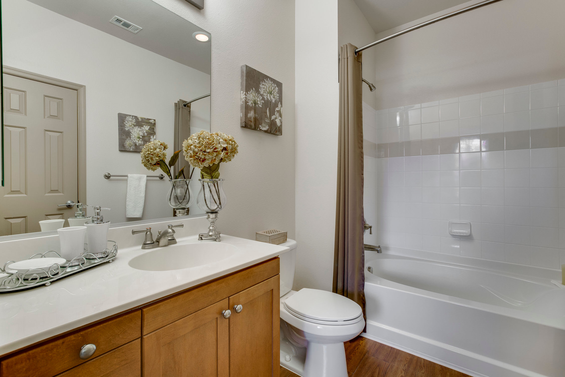 Bathroom with wood cabinets at Summerfield at Morgan Metro in Hyattsville, Maryland