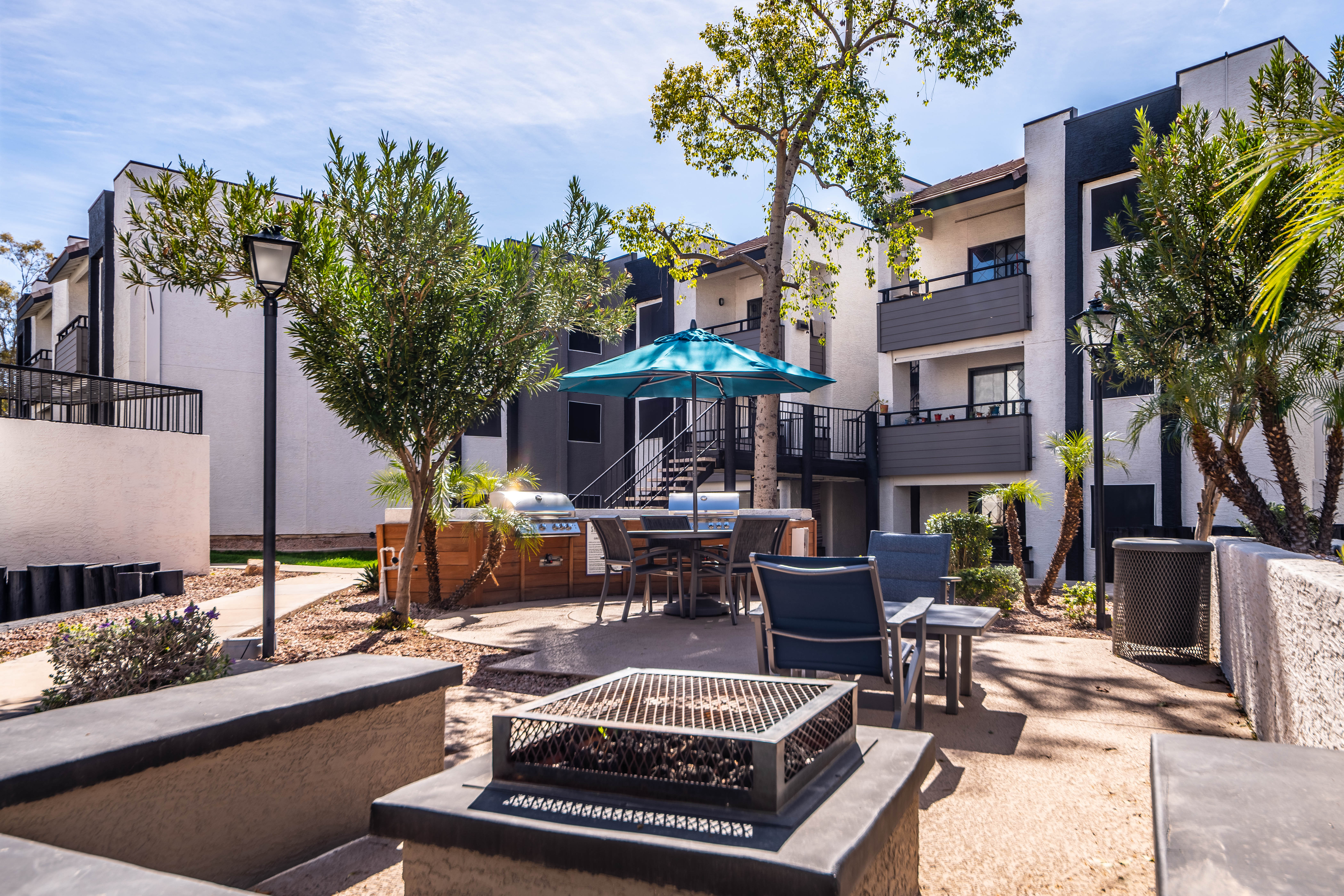 Exterior of an apartment building with private balconies and patios at Station 21 Apartments in Mesa, Arizona