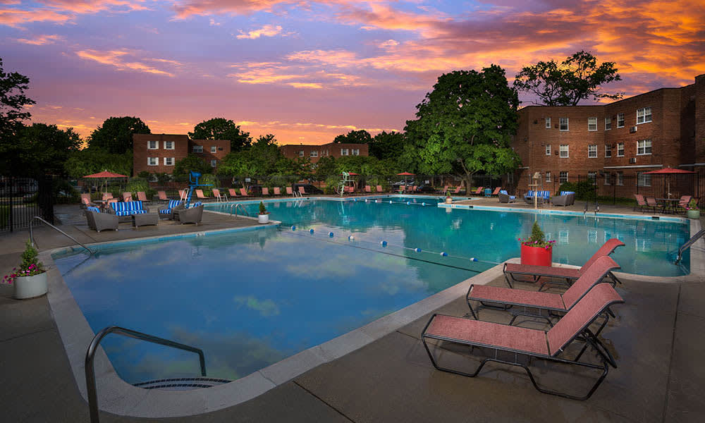 Our swimming pool with sun chairs at twilight in Mount Rainier, MD