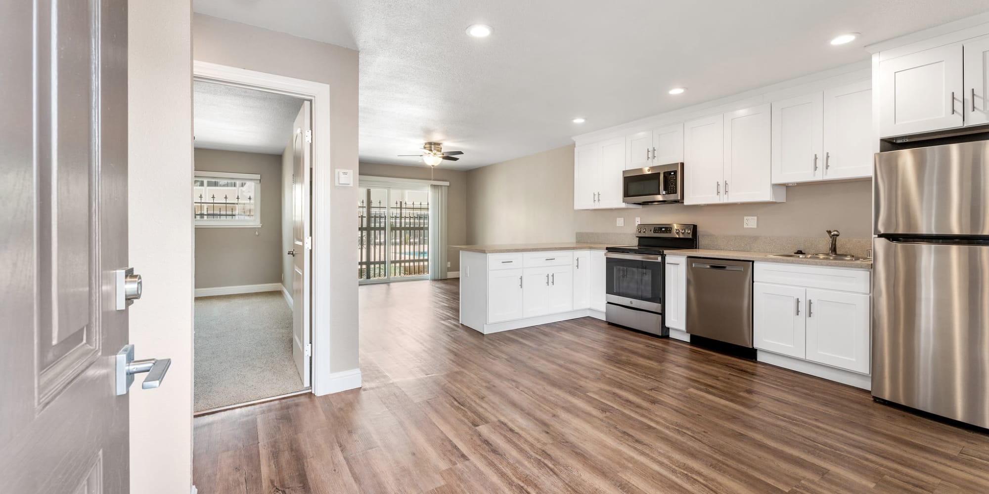 Hardwood flooring with stainless steel appliances at Fremont Arms Apartments in Fremont, California