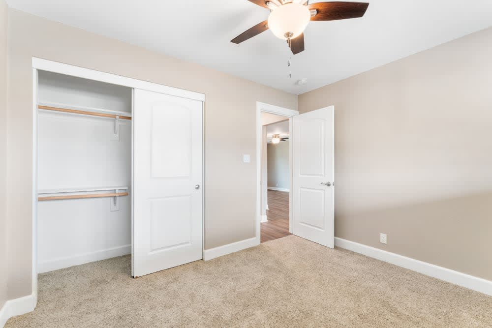 Carpeted bedroom with closet at Fremont Arms Apartments in Fremont, California