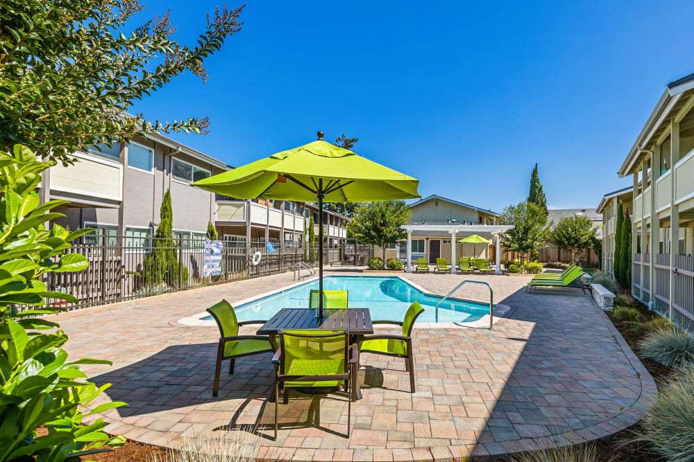 Seating area by the pool at Fremont Arms Apartments in Fremont, California