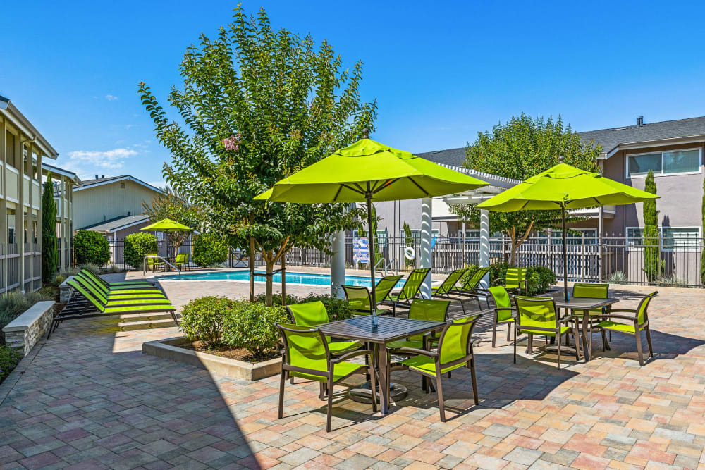 Courtyard seating next to the swimming pool at Fremont Arms Apartments in Fremont, California