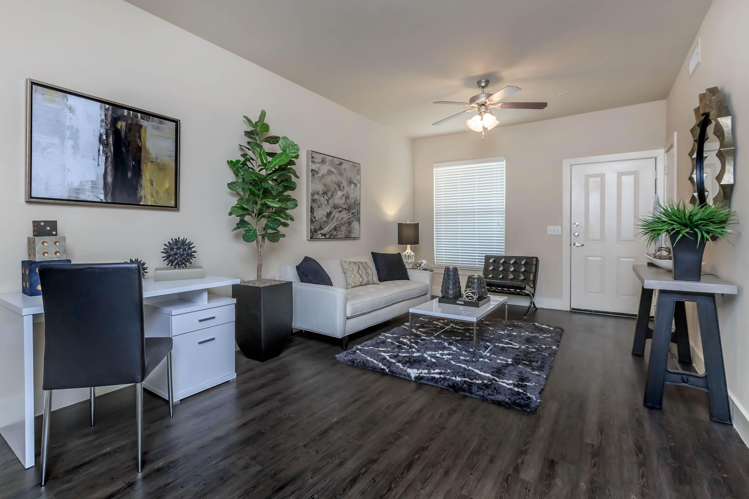 Furnished living room with wood-style flooring at Lotus Village in Austin, Texas