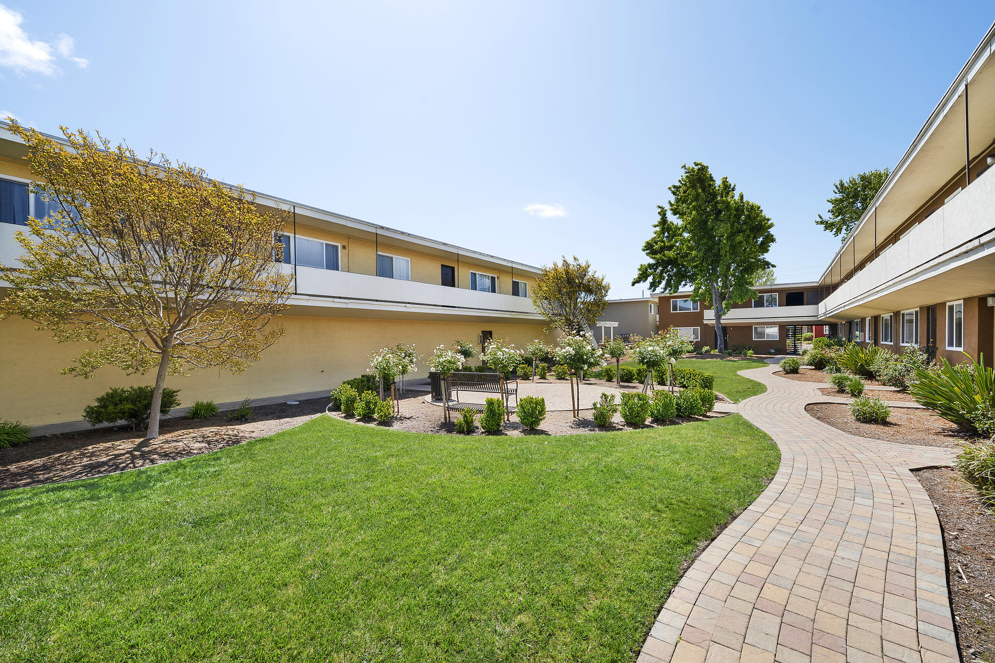 Well-manicured lawn and courtyard area at Garden Court Apartments in Alameda, California