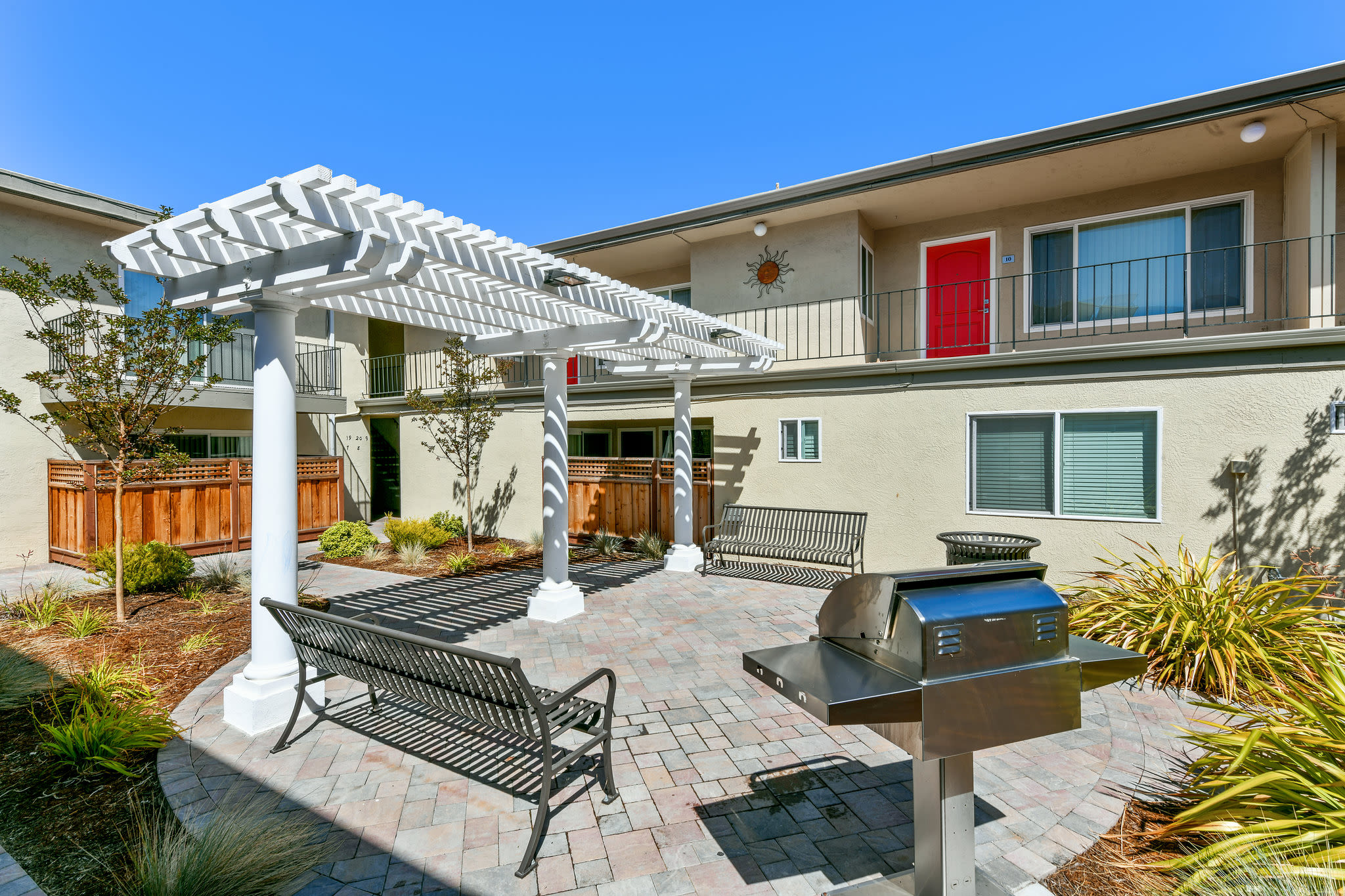Outdoor grill and picnic area with benches at Marina Haven Apartments in San Leandro, California