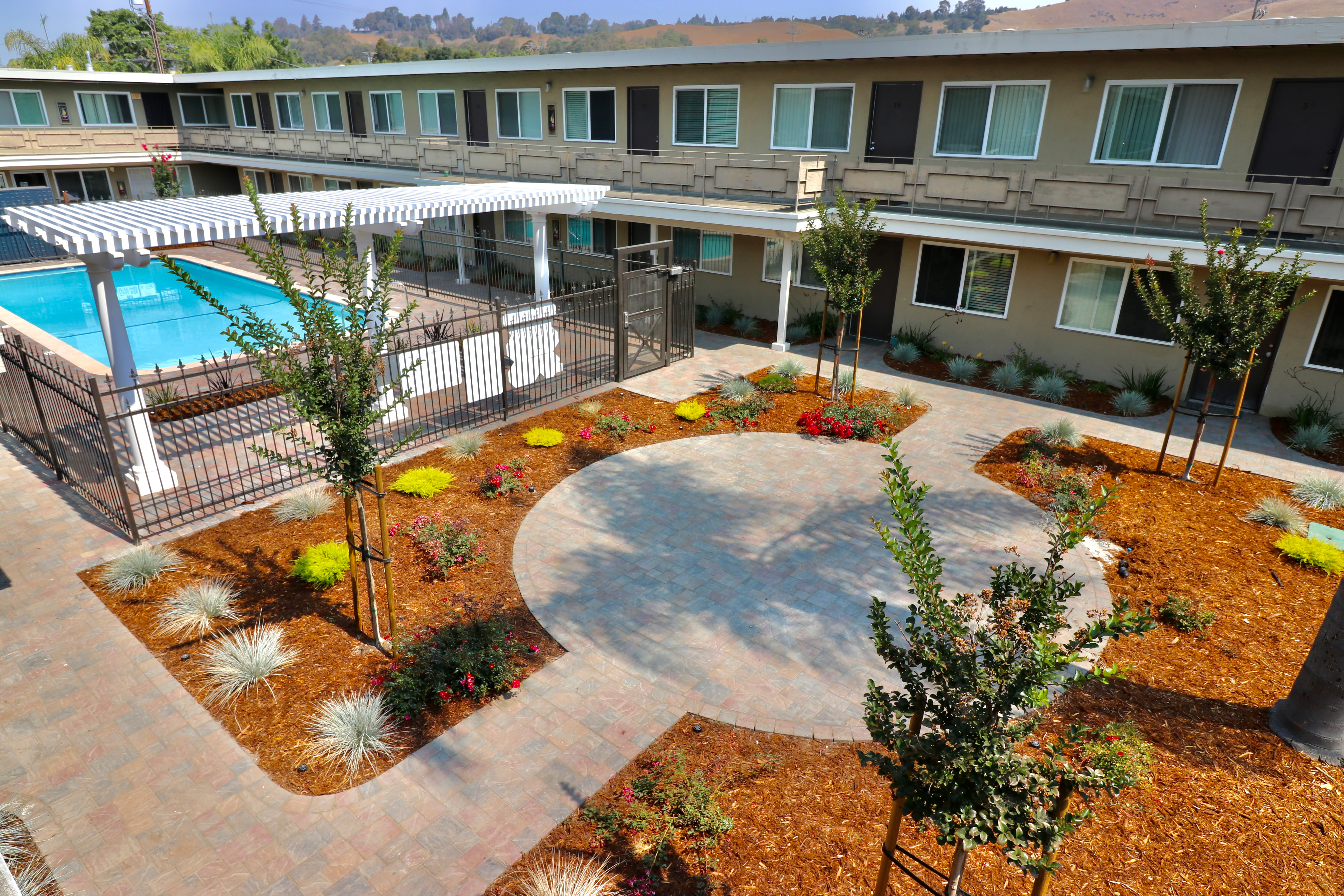 Pool area in the middle of apartment complex at Coral Gardens Apartments in Hayward, California