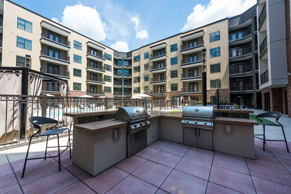 Alpharetta Luxury Apartments - Veranda Avalon - BBQ Grilling Station Is Near The Pool Area. The Grilling Station Has Two Gas Grills, Counterspace, And Chairs.